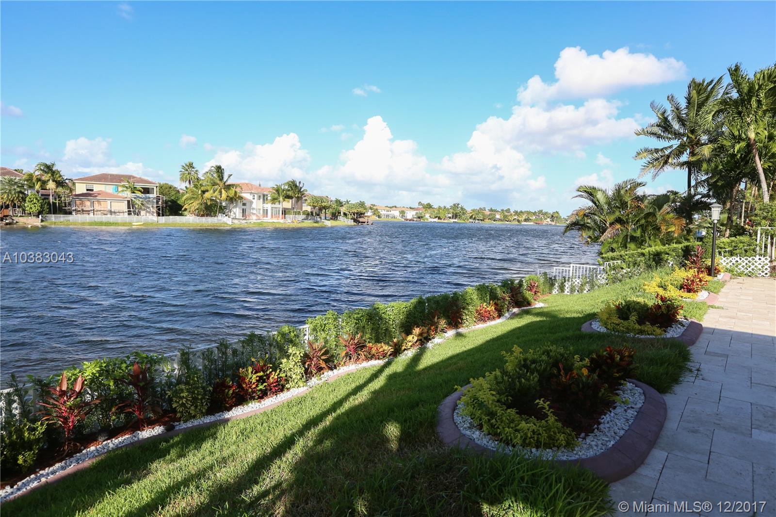 BEST HOME FOR SALE IN EXCLUSIVE DORAL ISLES! LAKE AND POOL COMBO! BETTER THAN A NEW HOME. THIS PROPERTY HAS BEEN COMPLETELY REMODELED: NEW ITALIAN PORCELAIN FLOORS, NEW KITCHEN WITH TOP OF THE LINE APPLIANCES AND IMPORTED MATERIALS, INDUCTION TECHNOLOGY COOKTOP, NEW BATHROOMS, IMPACT RESISTANT WINDOWS, NEW HEATED POOL WITH JACUZZI, OUTSIDE BBQ/KITCHEN/WET BAR AREA, ELECTRIC RETRACTABLE AWNINGS, BRAND NEW A/C, ELECTRIC BLINDS, IN MASTER BEDROOMS AND FAMILY ROOM, SECURITY CAMERAS AND MANY MORE UPGRADES.
