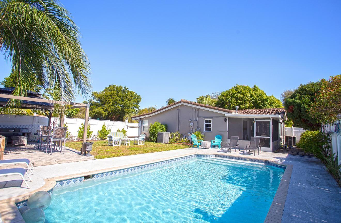 Beautifully updated 3-bedroom, 2-bath corner pool home in Pompano Beach just east of Federal Highway. This bright and inviting residence features hurricane impact windows and doors, an open-concept layout, and stylish finishes throughout. The kitchen boasts white shaker cabinetry with modern hardware, quartz countertops, and stainless steel appliances. Waterproof engineered flooring flows seamlessly through the home, complemented by updated lighting and contemporary ceiling fans. Enjoy a spacious backyard with a heated pool (newer pump), perfect for entertaining family and friends. Additional highlights include a convenient utility area with washer and dryer, extra storage space, outdoor shower, and a circular driveway offering ample parking. Ideally located just minutes from the beach, dining, shopping, and entertainment. A must-see property that blends comfort, style, and location!