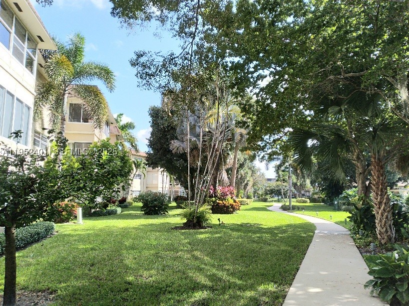 Stunning first-floor condo featuring 2 master bedrooms with a beautiful lake view, located in a quiet corner setting. The corner location adds extra windows, filling the home with natural light. Open kitchen with granite countertops. Enjoy direct access from the Florida room to the walking area, pool, community amenities, and lake. Tile flooring throughout. Upgraded bathroom with spacious walk-in shower and independent entrances for each bedroom.55+ Community .Al furniture and accessories are included in the sale.