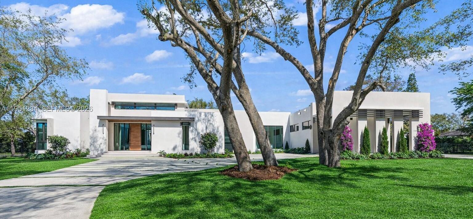 Brand new one-story corner modern masterpiece on an acre of land, over 8,660 SF surrounded by mature oak trees on scenic Old Cutler Road in North Palmetto Bay.  This one-of-a-kind estate includes TOP OF THE LINE finishes and smart home technology.  A total of 6 bedrooms with en-suit baths and 2 powder rooms; the layout includes a bedroom wing with 4 bedrooms and laundry and a guest wing with 2 bedrooms. For car aficionados, the expansive garage is designed with space for car lifts, plus a car port, enough room for 5 cars.  Enjoy a huge great room offering seamless indoor-outdoor living with volume ceilings, a floor to ceiling wine cellar display and full bar.  The Italian Pedini gourmet kitchen comes equipped with Wolf and Subzero appliances, and a hidden butler’s pantry. The family room, ideal for entertainment, is adjacent to a huge outdoor summer kitchen.  The expansive covered terrace boasts over 1,680 SF and the yard comes with an oversized pool and jacuzzi.  Surrounded by top schools, you won’t find another custom-built entertainer’s paradise like this in all of Miami.
For you tube video click on virtual tour.