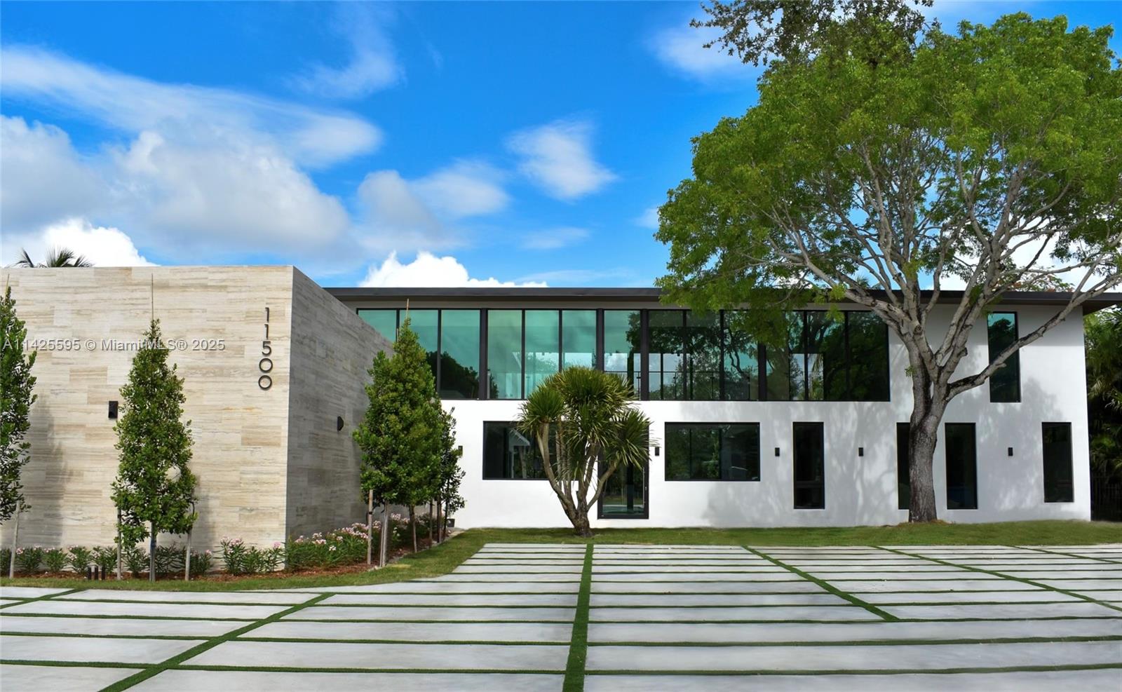 Experience refined living & luxury w/ this stunning modernist sanctuary by award-winning Hollub Group, AVAILABLE JULY 2025. Nestled on a sprawling Pinecrest acre, this turnkey new construction is the epitome of sophistication & style. Expansive floor-to-ceiling glass & organic materials seamlessly blend w/custom design & expert craftsmanship. Highlights: exceptional floor plan, bespoke Eggersmann kitchen w/Gaggenau /Wolf, huge prep  kitchen, club room with custom bar & fireplace, great room, family lounge, gym, and flex spaces. Outdoor oasis features a summer kitchen & lush landscaping, while the luxurious primary suite and energy-efficient construction elevate the experience. Automation, architectural lighting, elevator, generator, designer finishes. Strategically located/PinecrestSchools