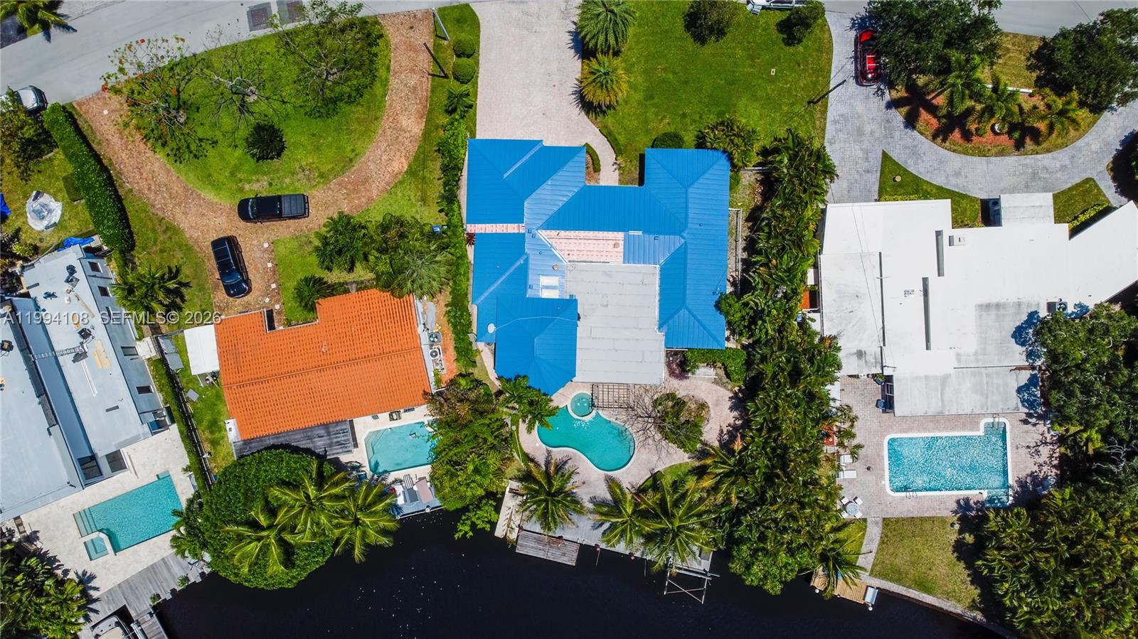 BRAND NEW DESIGNER METAL ROOF!!
Welcome to the sought-after community of Coral Shores, where luxury waterfront living meets everyday comfort.
This stunning residence has one of the most breathtaking views in the neighborhood, offering expansive wide-water views and 75 feet of prime waterfrontage. Inside, you’ll find two spacious main suites, each designed with comfort in mind. The remodeled kitchen is a chef’s dream and ready for entertaining. The massive master suite is a true retreat, featuring 12-foot tray ceilings, dual walk-in closets a custom A/C system, and all IMPACT windows and doors! Step outside to your dock, where you can launch a kayak, go boating, or simply enjoy the tranquil beauty of the water.The pool has an upgraded salt water system.This home perfectly combines coastal charm with modern luxury. (Also available for LEASE $9500 per month))
