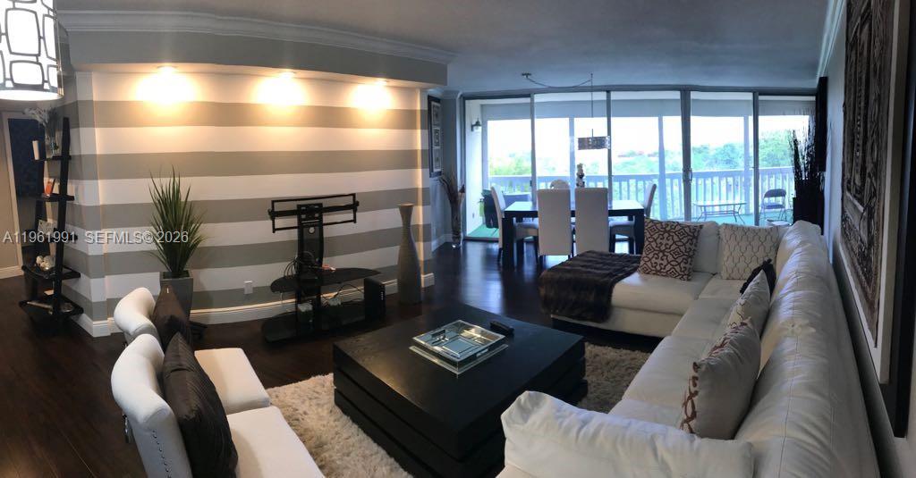 Wow! This stunning 2/2 condo is completely remodeled from top to bottom. No detail left undone. Beautiful wood laminate floors and 5 1/4 inch crown molding throughout. Kitchen features custom built cabinets, quartz countertops, and stainless steel appliances. Relax on the spacious screened in balcony. The laundry facility is located on the same floor. Guard gated community and secured building, minimum income and 670 credit score requirements.