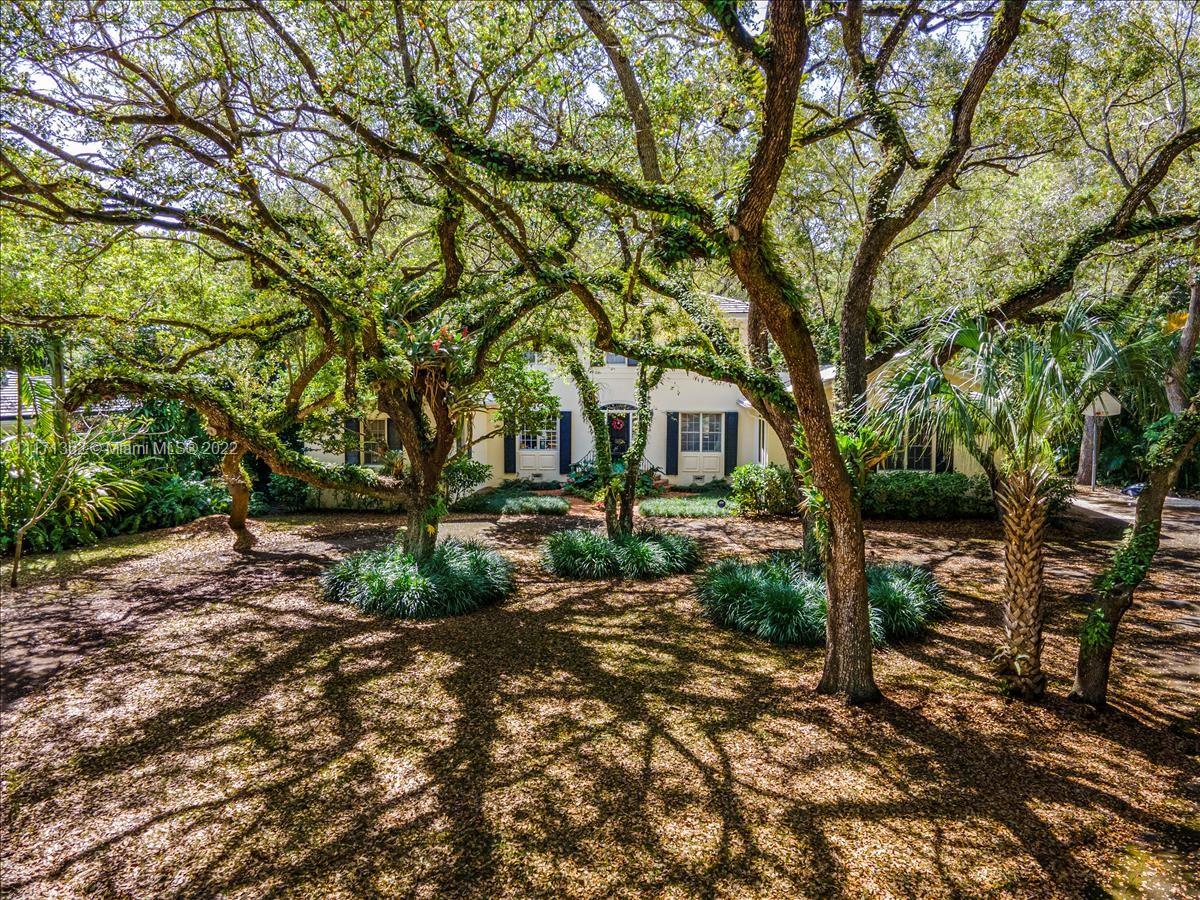Privacy is complete in this acre property hidden away by grand oak trees the seem to embrace the home. Property is very deep at 42, 689 sq ft of beautiful shady lawn. Found at the end of a cul-de-sac on a street that is only two blocks from Cocoplum Circle. You will drive pass beautiful homes until the street becomes Unincorporated Dade County to find this property the last on the left. ( So think of the heart of the Gables but not the taxes. ) The house is five bedroom/4 full baths with high ceilings. It can be renovated or removed for a new creation in this estate setting that is impossible to find! Opportunity knocks.