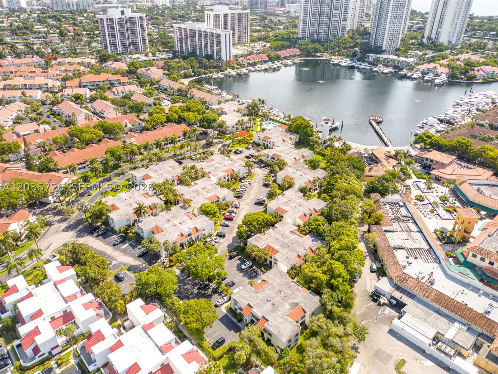 Welcome to this beautifully updated 2-bedroom, 2-bath garden apartment in the highly sought-after gated community of Aventura Waterways. Offering 1,096 square feet of living space, this ground-floor residence features a desirable split-bedroom floor plan and has been completely renovated from top to bottom.

The open-concept kitchen is equipped with stainless steel appliances, including an LG refrigerator, Samsung dishwasher, and Frigidaire range, creating the perfect space for cooking and entertaining. Both bathrooms have been tastefully updated with modern walk-in showers, while the primary suite features dual vanities for added convenience.

Recent improvements include new flooring, LG washer and dryer, LG refrigerator, and A/C system, all completed in 2023-2024. The home showcases elegant 18x18 tile flooring and high-quality wood laminate throughout and has been freshly painted, making it truly move-in ready.

A unique feature is the enclosed patio area off the kitchen and living room, thoughtfully converted by a previous owner into a flexible office, den, or hobby space.

Residents enjoy a secure, gated community with 24-hour security, sparkling pools, marina access, and beautifully maintained grounds. Ideally located just minutes from the world-class shopping and dining of the Aventura Mall, Gulfstream Park, Whole Foods Market, and Target, with easy access to top-rated schools, beaches, airports, and major highways