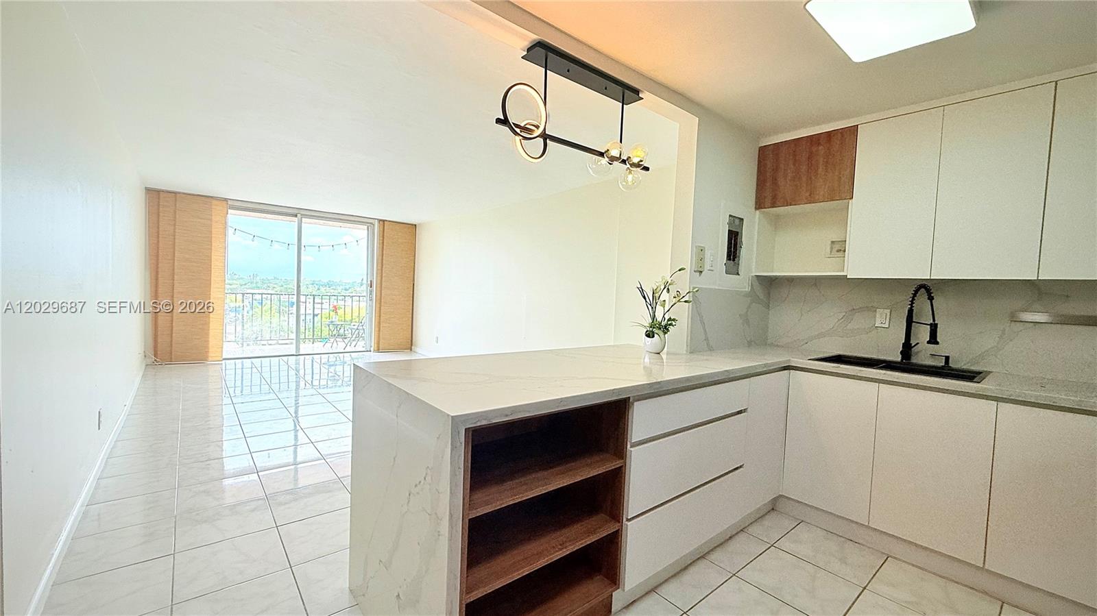 AVAILABLE AUGUST 1, 2026- Enjoy a bright, open-concept living space with tile flooring, a modern kitchen featuring quartz countertops, custom cabinetry, and black stainless steel appliances. The bathroom has been elegantly renovated with a glass-enclosed shower, gold fixtures, and stylish finishes. Rent Includes: Water/Hot water, garbage, 1 assigned parking space, and 1 storage. Gated building with secured entry and community pool. Centrally located near FIU, Barry University, Whole Foods, shops, beaches, and major highways.