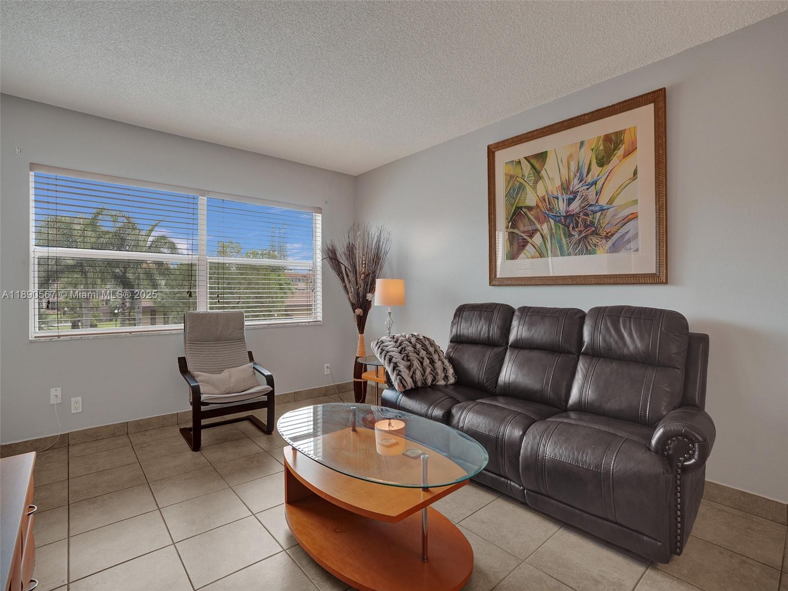 Beautiful 1-bedroom unit with serene lake and pool views, located on the second floor. The Florida room can easily be converted into a second bedroom. Sold fully furnished with ceramic floors throughout. Internet is included in the monthly fees and the 50-year inspection has been completed. The backyard is secured with a locked fence for added privacy and safety. This vibrant HOPA community offers fantastic amenities including a pool, clubhouse, gym, and shuffleboard. Perfect location close to shopping, dining, and beaches. Easy to show!