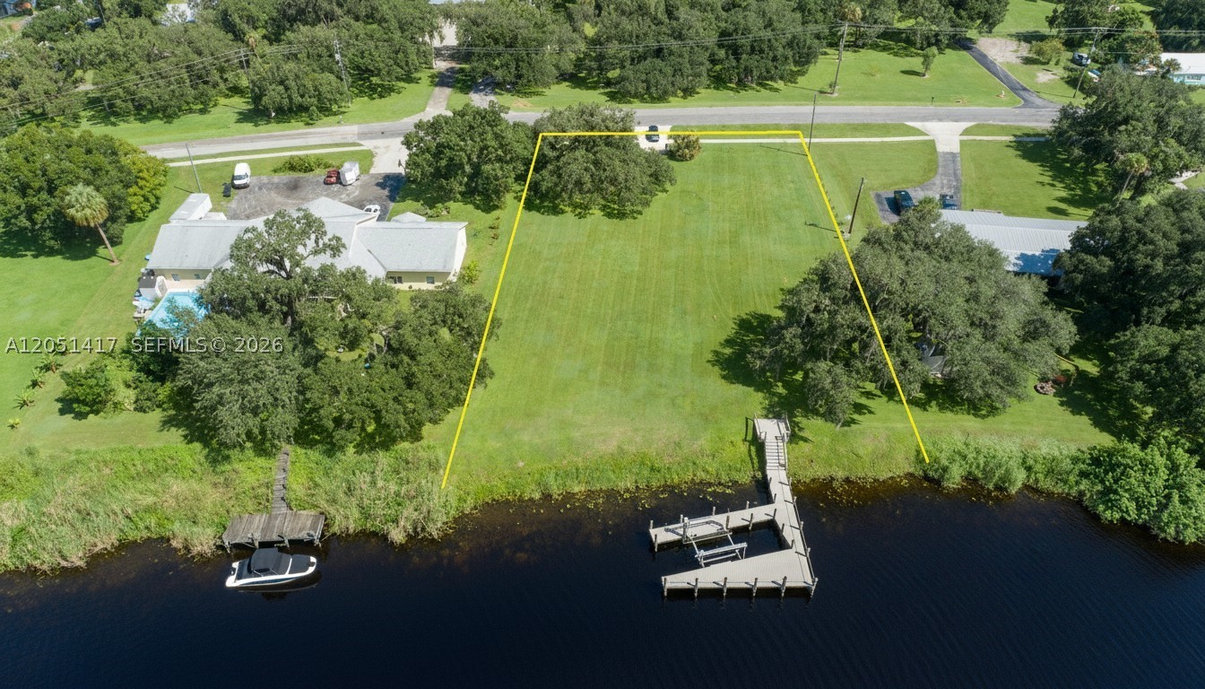 Rare Intracoastal Riverfront Homesite! This exceptional cleared waterfront lot is ready for your custom dream home and already features a driveway, underground electric, and a brand-new private dock with a boat lift and maintenance-free composite decking. Enjoy direct deep-water access to the Gulf, the Atlantic Ocean, and Lake Okeechobee via the Okeechobee Waterway. One of the property’s most desirable features is that the homesite is outside the flood zone and is not subject to tidal fluctuations or storm surge, offering added peace of mind. Conveniently located just outside the LaBelle city limits, you’ll be within walking distance of the LaBelle Yacht Club for waterfront dining and Barron Park, where you can enjoy festivals, live entertainment, and community events throughout the year. This is a rare opportunity to own a premier waterfront homesite in one of Southwest Florida’s most desirable riverfront locations.