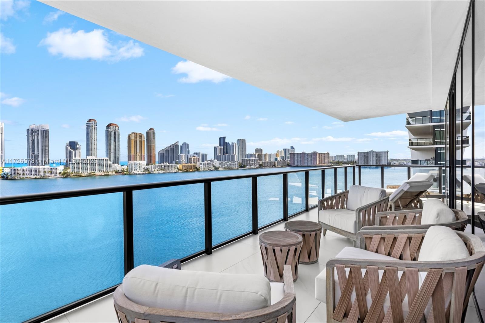 Experience luxury living at Privé at Island Estates. This sprawling 4-bedroom, 5.5-bathroom corner residence offers breathtaking, unobstructed water views from every room. Designed in a refined contemporary transitional style, the home boasts premium Miele appliances, a bespoke wet bar, and exquisite porcelain tile flooring. Expansive, open spaces seamlessly transition to oversized balconies, perfect for savoring both sunrises and sunsets. Interiors by Steven G embody timeless elegance, blending sophistication with comfort. Enjoy world-class amenities, including a two-story gym, private marina, tennis court, spa, & over 70,000 SqFt of exclusive social spaces. Moments from Bal Harbour, Aventura Mall, and Sunny Isles Beach—this is the epitome of luxurious Williams Island living. Call today!