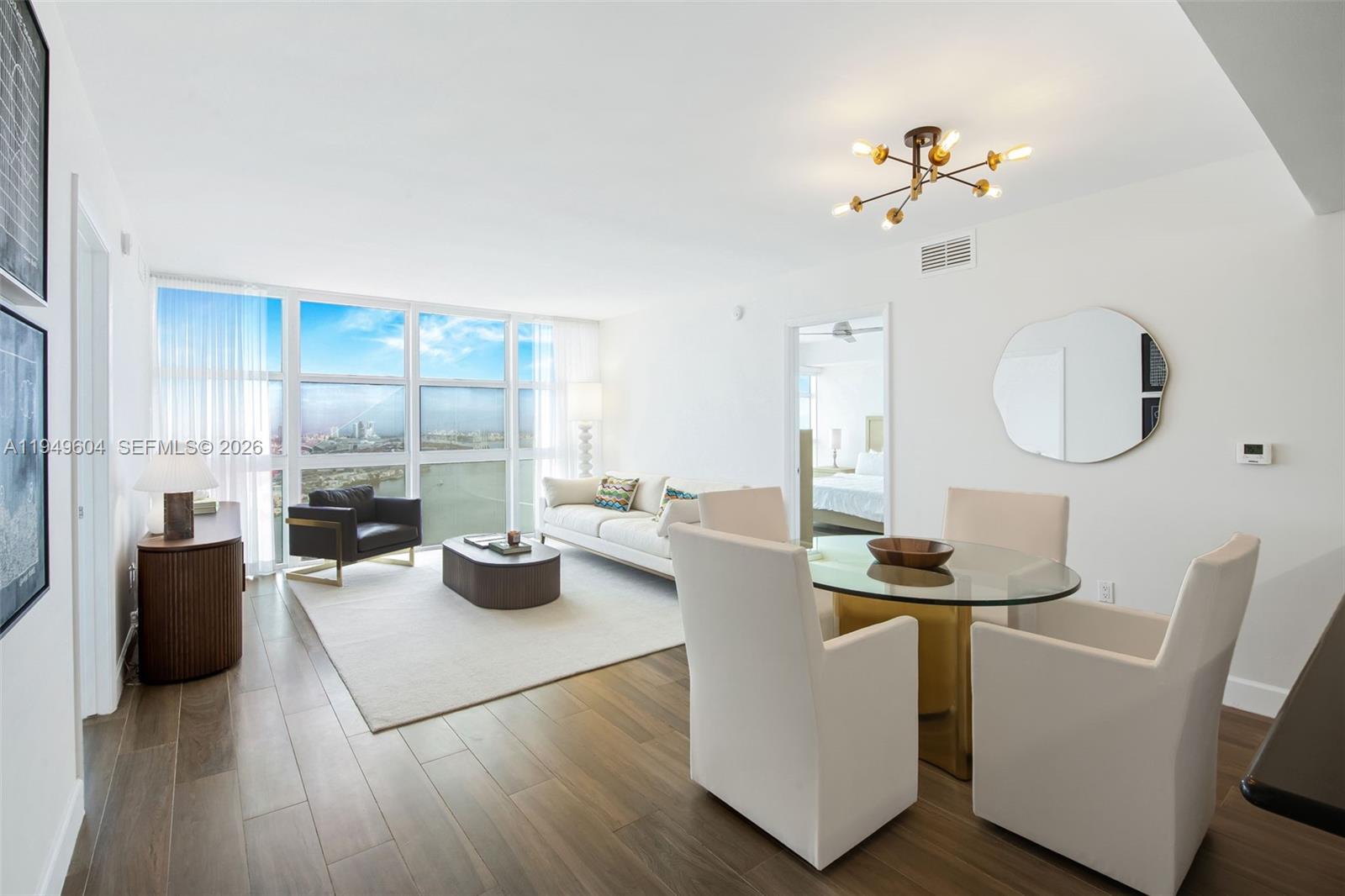 Refined Downtown Miami living awaits from this expansive 39th-floor 2 Bed + Den / 2 Bath residence at iconic 50 Biscayne, offered fully furnished for a truly turnkey opportunity. This large east-facing home is filled with natural light and framed by floor-to-ceiling impact glass showcasing sweeping views of Biscayne Bay, Bayfront Park and the Miami Beach skyline. The open-concept living and dining areas offer a seamless setting for entertaining, complemented by a sleek kitchen with black stone countertops, stainless steel appliances, and generous storage. A spacious den provides flexibility for a private home office, media lounge, or guest space, while the desirable split-bedroom layout enhances privacy and livability. The oversized primary suite features ample closet space and a spa-inspired bath with dual vanities, soaking tub, and glass-enclosed shower. Contemporary flooring, in-unit washer/dryer, and a clean neutral palette complete this move-in ready residence. 50 Biscayne offers full-service, resort-style amenities including a grand pool deck with cabanas and BBQ area, modern fitness center, sauna, steam and massage rooms, locker rooms, two resident lounges, business center, valet, 24-hour security, and concierge services. Ideally positioned just ssecondsfrom Bayfront Park, Bayside, Whole Foods, Kaseya Center, the Metromover, and minutes to Brickell City Centre with world-class dining, shopping, and nightlife.