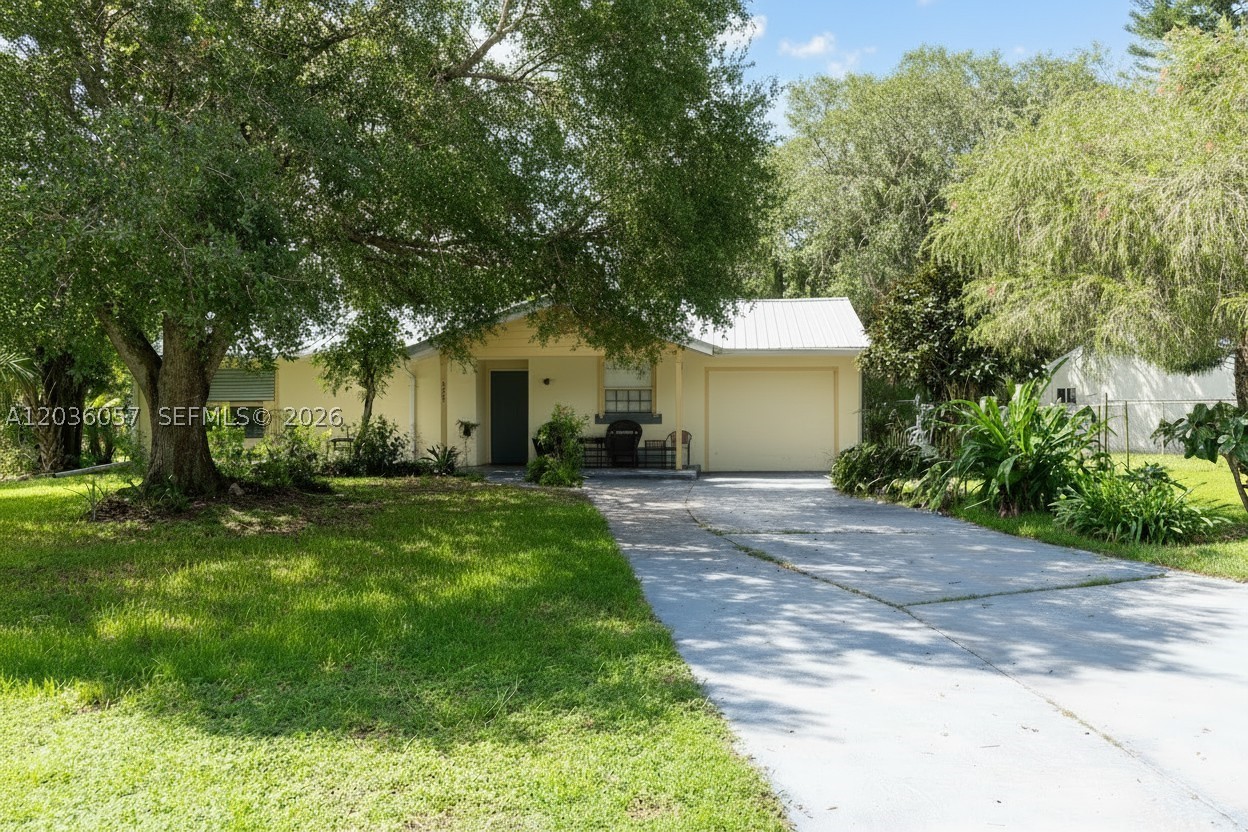 Situated on a desirable corner lot with greenbelt views, this well-maintained home offers peace of mind and low-cost ownership. Highlights include a metal roof, storm shutters for every window, a fenced backyard with shed & a variety of fruit trees, and a screened lanai ideal for outdoor living. Community amenities — pool and park — are just a short walk away. Not located in a flood zone, and HOA dues are an exceptional value at only $180/year.