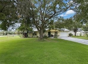 Situated on a desirable corner lot with greenbelt views, this well-maintained home offers peace of mind and low-cost ownership. Highlights include a metal roof, storm shutters for every window, a fenced backyard with shed & a variety of fruit trees, and a screened lanai ideal for outdoor living. Community amenities — pool and park — are just a short walk away. Not located in a flood zone, and HOA dues are an exceptional value at only $180/year.