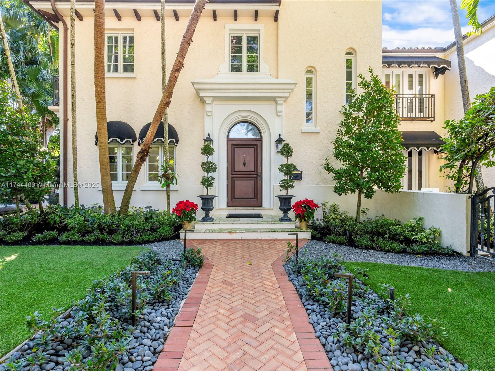 Experience sophisticated living in this elegant Coral Gables residence, gracefully situated on a coveted corner lot along the iconic Columbus Blvd. This beautiful Old Spanish-style home boasts 3,896 square feet of luxuriously appointed, light-filled living spaces. The gourmet eat-in kitchen, equipped with a gas stove, flows seamlessly into the airy interiors, complemented by rich hardwood floors. Upstairs, discover four spacious bedrooms, including a serene primary suite. The home offers multiple retreats and peaceful escapes, enhanced by a loggia, summer kitchen, and patios that frame a sparkling pool, inviting year-round indoor/outdoor entertaining. Surrounded by centennial Banyan Trees and lush landscape, this property embodies the epitome of the highly-coveted Gables lifestyle.