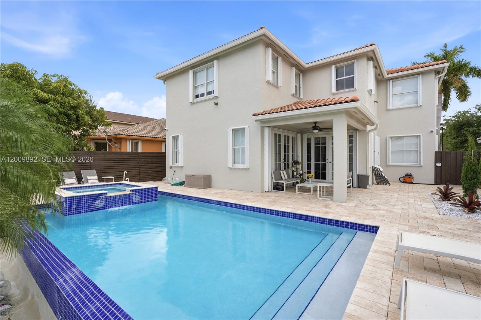 Stunning San Cristobal model in the heart of the sought-after Islands at Doral. This spacious 2,975 SF residence features 4 bedrooms and 4 full bathrooms, including a highly convenient bedroom and full bath on the ground floor. Enjoy expansive lake views from the light-filled living areas and the luxurious master suite. The private, screened-in heated pool and spa overlook the water, creating a resort-style retreat. Highlights include high volume ceilings, an elegant mix of tile and wood flooring, and a 2-car garage. Just steps from the community clubhouse and A-rated schools. A true executive home in an unbeatable location.