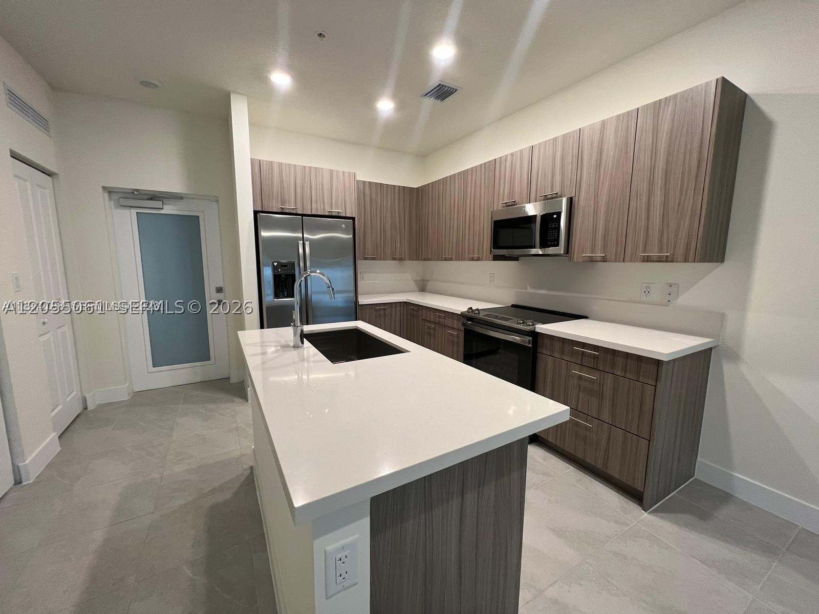 Welcome to this beautifully updated 3-bedroom, 2-bathroom first-floor residence in the highly desirable Urbana at Downtown Doral. Featuring brand-new luxury vinyl flooring throughout, this move-in-ready home offers a modern, elegant feel with the convenience of single-level living.

The open-concept layout is complemented by an in-unit washer and dryer, generous living spaces, and the added convenience of an assigned parking space located directly in front of the unit.

Residents enjoy access to Urbana's exceptional resort-style clubhouse, featuring a state-of-the-art fitness center, swimming pool, basketball court, children's splash park, playground, social lounges, and beautifully maintained green spaces.

Perfectly situated in the heart of Downtown Doral, this home is just minutes from premier shopping, fine dining, parks, entertainment, Miami International Airport, and major highways, providing easy access to all that Miami has to offer. The community is also surrounded by some of Doral's most sought-after schools, including highly regarded charter and public schools, making it an excellent choice for families.

A rare opportunity to lease a stylish, updated home in one of Doral's most desirable communities.