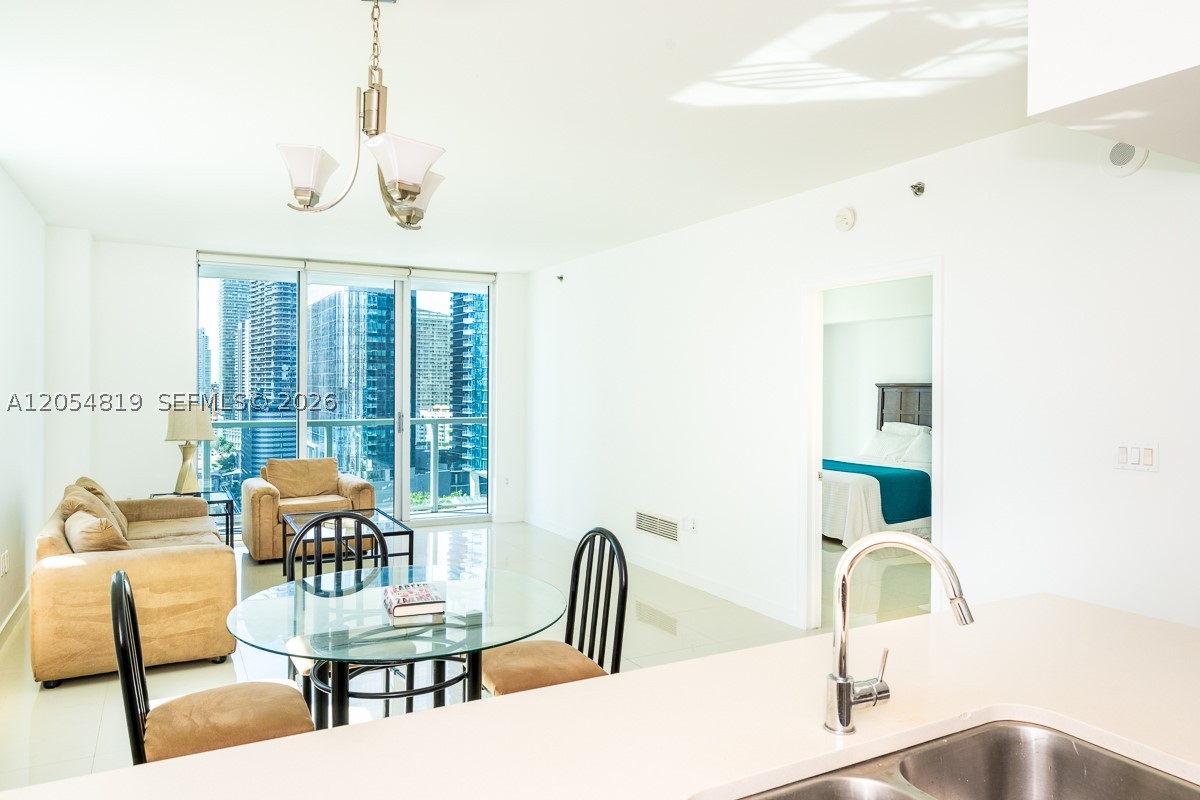 Spectacular 2-bedroom, 2-bathroom corner unit, offering bay and city views from the living room and terrace. Designed by Arquitectonica, this exquisite home features Italian porcelain tile floors, floor-to-ceiling windows, and a gourmet kitchen with high-end appliances. The primary suite boasts an oversized walk-in closet and a spa-inspired bath, creating a serene retreat. Indulge in world-class amenities, including a 42nd-floor rooftop pool, an 11th-floor circular pool, a state-of-the-art fitness center, a spa, a club room, and a private theater. With full-service concierge, assigned parking, and valet options. Just steps from premier dining, shopping, and entertainment. This is Miami living at its finest. Schedule your private showing today!