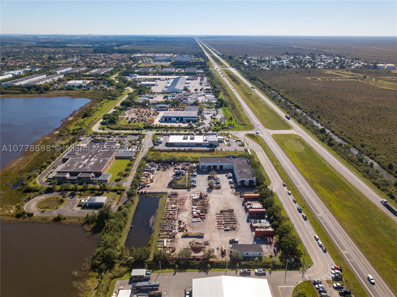 This 15,245 SF warehouse & office within 4.33 Acres (zoned M-2) right US-27. 3,000 SF of office with impact windows. 20 ft & 25 ft clear ceiling height, sprinkled.  3 phase power - 270 amps. Acreage is filled and graded, ready for industrial use or storage. Fenced property, electric gate. 34 striped parking spaces.