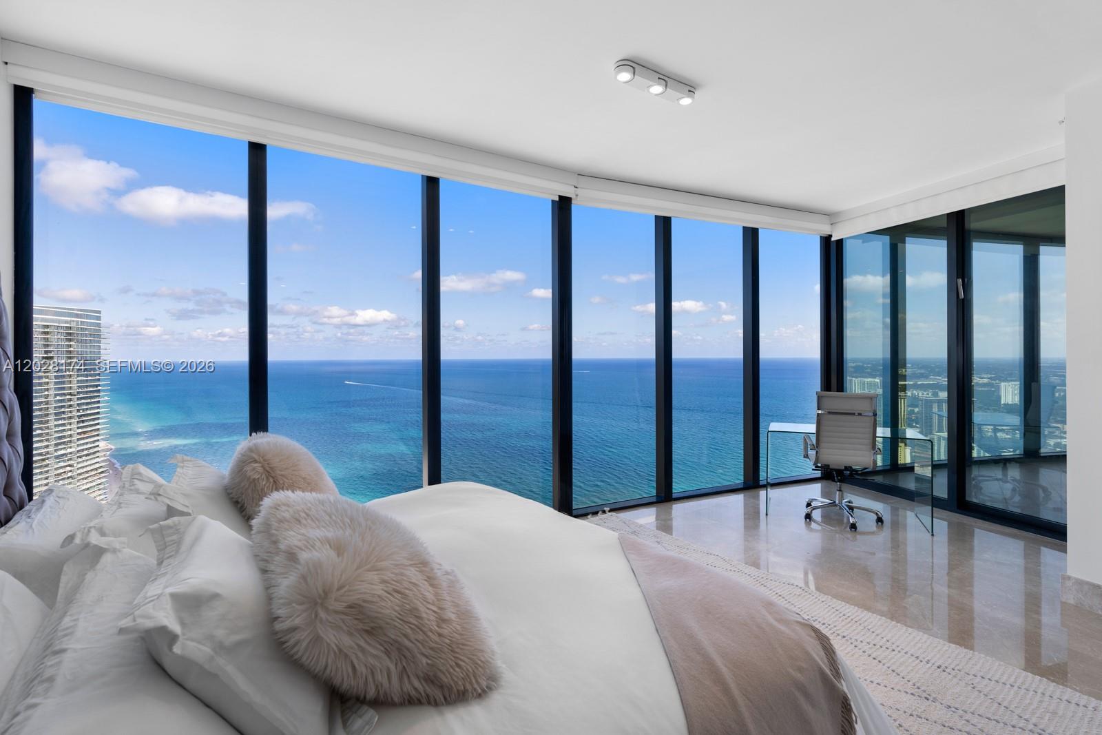 Residence 5105 at the iconic Porsche Design Tower showcases the most beautiful and unobstructed ocean views in the building from its coveted 51st-floor position. This exceptional 4-bedroom sky residence seamlessly blends innovation, privacy, and luxury, featuring a private 2-car sky garage accessed through the tower's signature Dezervator.
Designed for elevated living, the residence features marble floors, custom closets, automated blinds, TOTO smart toilets, and a stunning Poggenpohl kitchen appointed with premium Miele appliances. Floor-to-ceiling glass frames breathtaking water views and opens to an expansive terrace complete with a private plunge pool and summer kitchen.
Enjoy an unparalleled lifestyle with world-class amenities including private chef and room service, a private restaurant and bar, oceanfront spa, state-of-the-art fitness center, concierge services, valet, and premier security. One of the tower's most sought-after residences, offering a rare opportunity to experience Porsche Design Tower at its finest.