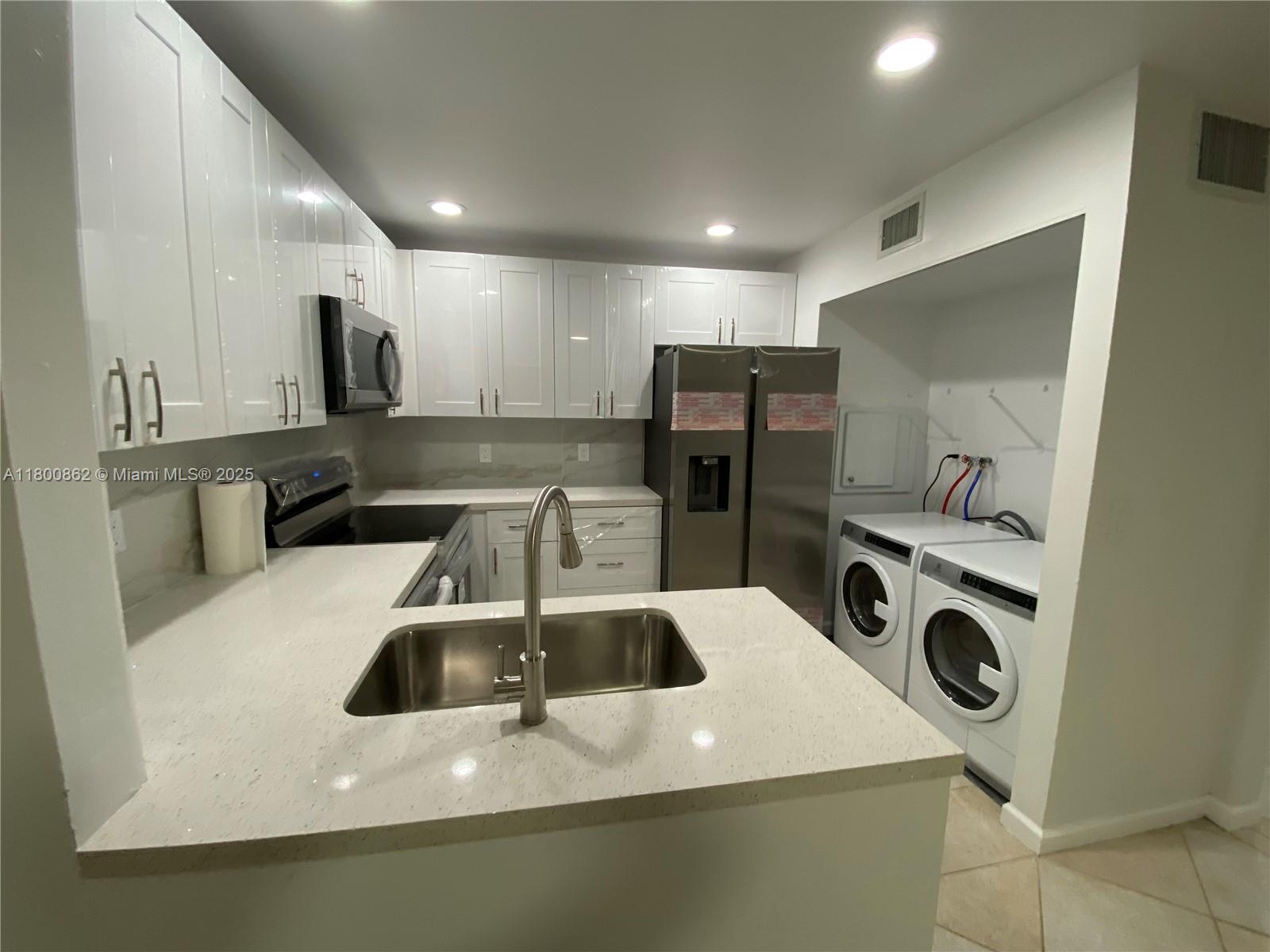 Move-in ready townhouse  in Palm Beach Gardens.  Two-story townhome features 2 bedrooms and 1 full bath upstairs plus 1 half bath on the first floor. Corner townhouse with privacy fence, private entrance with a nice garden and yard. 2 Parking spaces in front. Enjoy the screened patio, brand new kitchen with granite countertops, stainless steel appliances and a spacious living area with a charming fireplace. Modern bathrooms, tile flooring downstairs, recent A/C, 2025 new roof is been installed. Minutes from schools, medical services, daily essentials and commuter routes. Seller is offering  $5,000 credit to the buyer at closing with full-price offer  for closing costs or interest rate buy-down.  2 pets up to 40 pounds each allowed. No rental restrictions.