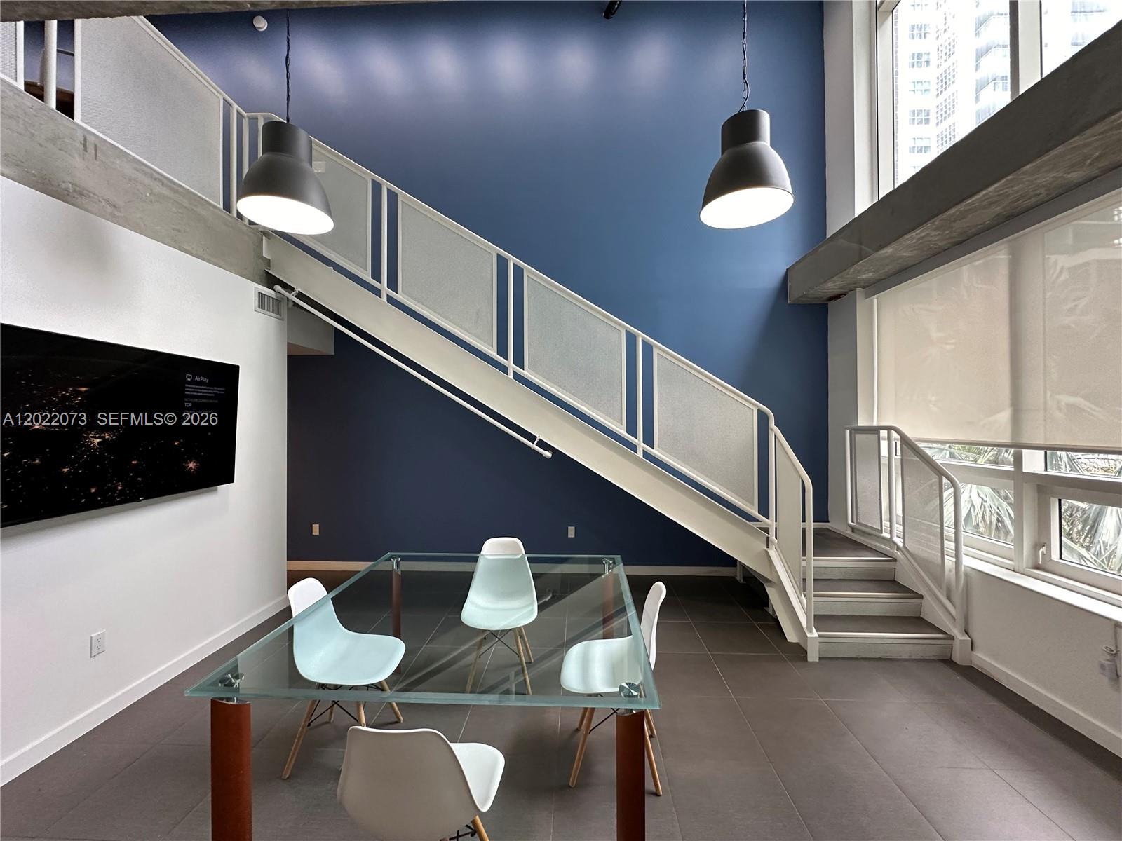 Welcome to Midblock Miami, where urban living meets creative flexibility. This stunning 2-story loft in the heart of Midtown offers 1,176 sq ft of versatile space bathed in natural light. The main level features an open kitchen, dining area, full bathroom, and a private balcony — perfect for morning coffee or evening relaxation. Head upstairs to find a spacious master bedroom, a large creative/work area ideal for a home office or studio, and a second balcony with city views. Building amenities include a 24/7 attended lobby, assigned parking on the same floor, fitness center, and BBQ area. Whether you're looking for a primary residence, live-work space, or a high-performing Airbnb investment, this loft delivers endless possibilities. Steps from Trader Joe's, Target, Wynwood's art scene, and the best dining Midtown has to offer. Easy access to Downtown Miami, Brickell, and South Beach makes this one of the most connected addresses in the city. Don't miss this rare opportunity to own a true live-work loft in one of Miami's most sought-after neighborhoods! WITH 2 PARKINGS