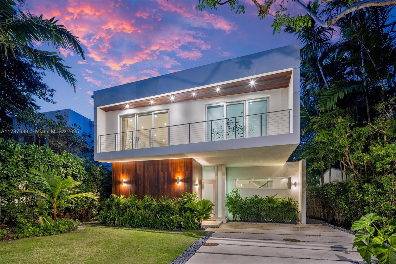 Stunning 5BD/4.5BA custom home in Coconut Grove, fully renovated with luxury finishes and thoughtful design. Features include travertine marble floors, real wood upstairs, a Poliform kitchen with Miele appliances, Lutron lighting, designer wallpapers, and custom millwork. Open layout with soaring ceilings and abundant natural light. The former atrium was enclosed to create an upstairs family room, adding valuable interior square footage. The primary suite offers a walk-in closet, spa-like bath, and private balcony. Outdoors, enjoy a lushly landscaped terrace, lap pool, custom BBQ, and a private roof deck. New roof, waterproofing, balcony tiles, gutters, and upgraded septic. Smart home features, custom drapes, and a whole-house Kinetico water filtration system complete this turnkey retreat.