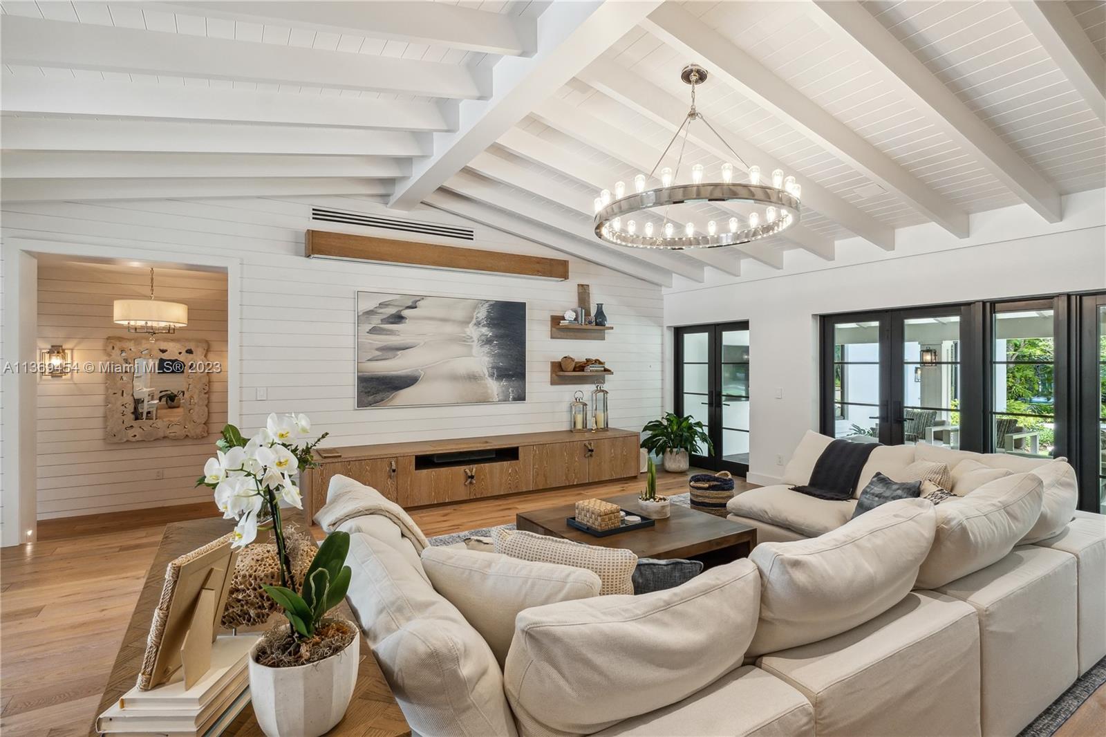 As you step into Casa Paraiso, you're transported to a tropical paradise in Miami. This one-of-a-kind home, completed in 2021, that comes FULLY FURNISHED draws inspiration from the Caribbean Islands. With over 7,000 sq ft of living space, the outdoor area is breathtaking, featuring an 11ft lagoon pool, fire pit, tennis/basketball court, and outdoor BBQ/pizza kitchen. Inside, enjoy exquisite nautical and warm interiors that boast high vaulted ceilings, a chef's gas kitchen, a private dining area, a 300-bottle wine cellar, a dream garage, beautiful blonde oak wood floors, custom millwork, and seven luxurious suites. Casa Paraiso is minutes from top restaurants and premier shopping, offering the perfect blend of tropical luxury and city living.