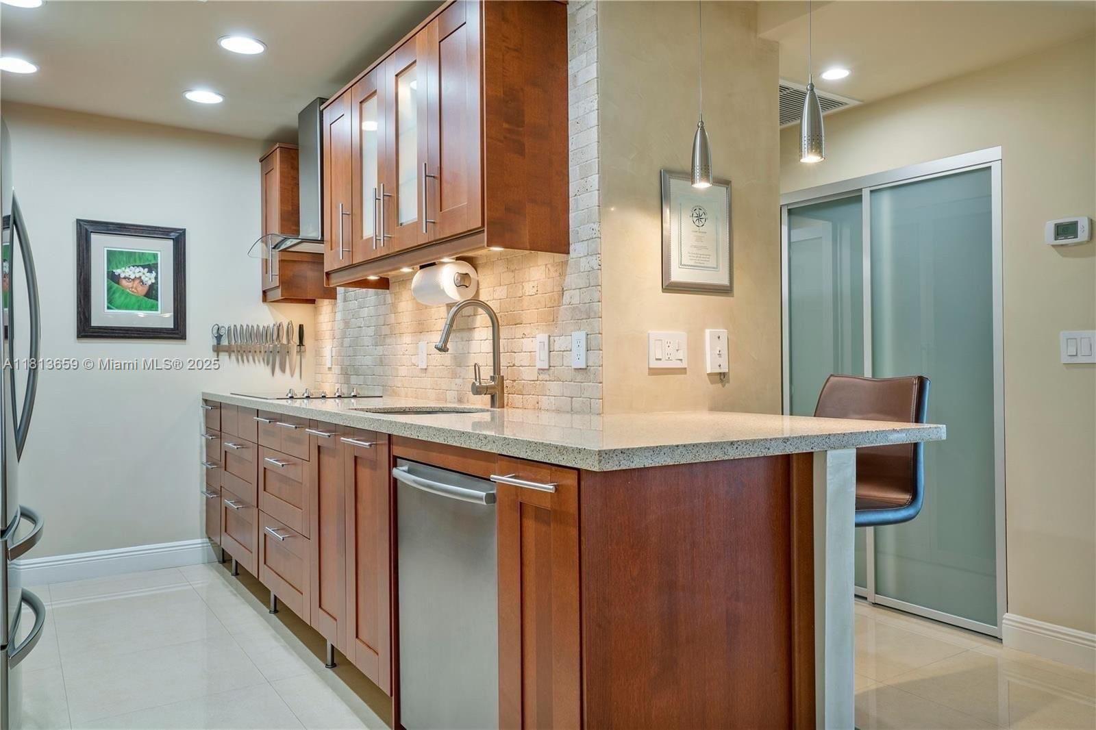Stunning one of a kind Studio with unobstructed Million Dollar views of the Intracoastal and Miami. Only steps from the Ocean. This studio has been renovated with the utmost detail and appointments. Magnificent kitchen, with stainless-steel high-end appliances, Quartz countertops, under cabinet lighting, Travertine style brick backsplash, Porcelain flooring throughout, crown molding, Venetian finished accent wall, smooth finished walls and ceiling, PGT Impact sliding door, updated electrical throughout, newly replaced A/C and ducts. Custom glass closet doors, Custom Closet System, Exquisite queen size Murphy bed unit. Unit comes with an assigned covered parking spot and extra storage space. This unit is a must see !!!
