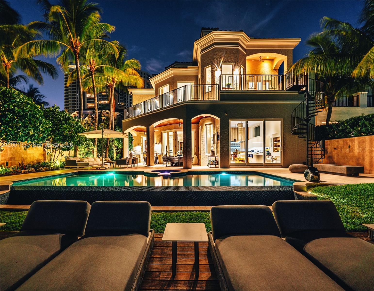 One of South Florida's most extraordinary waterfront estates, set on an exclusive private island within the 24/7 gated enclave of Island Estates, Aventura. Surrounded by the Intracoastal Waterway, this magnificent 3-story residence offers breathtaking panoramic water views from virtually every room — the kind of views that truly take your breath away.

Soaring double-height curved glass walls flood the interiors with natural light and frame the shimmering water beyond. The gourmet chef's kitchen anchors a grand open living space with a Calacatta marble island, custom cabinetry and professional appliances. A dedicated bar room with floor-to-ceiling illuminated glass wine cellar sets the stage for unforgettable entertaining. The spa master suite features a custom Italian walnut walk-in closet, a luxurious bathroom and private balcony with sweeping water views.

Outside, a heated infinity pool and spa overlook the Intracoastal, complemented by a fully equipped summer kitchen with live-edge bar, designer outdoor lounge and private waterfront deck framed by mature palms and the spectacular Aventura skyline.

A true boater's paradise: included in the sale is a private 100-foot slip at Island Estates Marina with direct ocean access via Haulover Inlet. 6 bedrooms, 7 bathrooms, guest house, staff quarters, 6,932 sq ft. Sold completely turn-key — fine art, custom sculptures, Italian designer furniture and all furnishings included. Arrive and begin living.