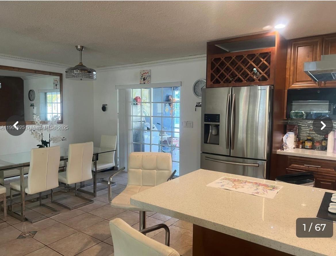 Incredible one-story house for sale. UNIQUE OPPORTUNITY! 5 BR 4 BA | 1 ADDITIONAL APARTMENT WITH 1/1 - LOTS OF SPACE! Enjoy the large open kitchen with stainless steel appliances. Includes a family room with wet bar overlooking the patio and enormous pool, a massive 14,000 square foot backyard with ample room for additions and potential for boat/RV storage or sports fields, and a two-car garage that converts to a studio. High impact windows, quartz countertops. This centrally located home is within walking distance to entertainment, schools, parks, playgrounds and shopping centers. Just ten minutes from the newly built Hard Rock Hotel & Casino, Hollywood Beach