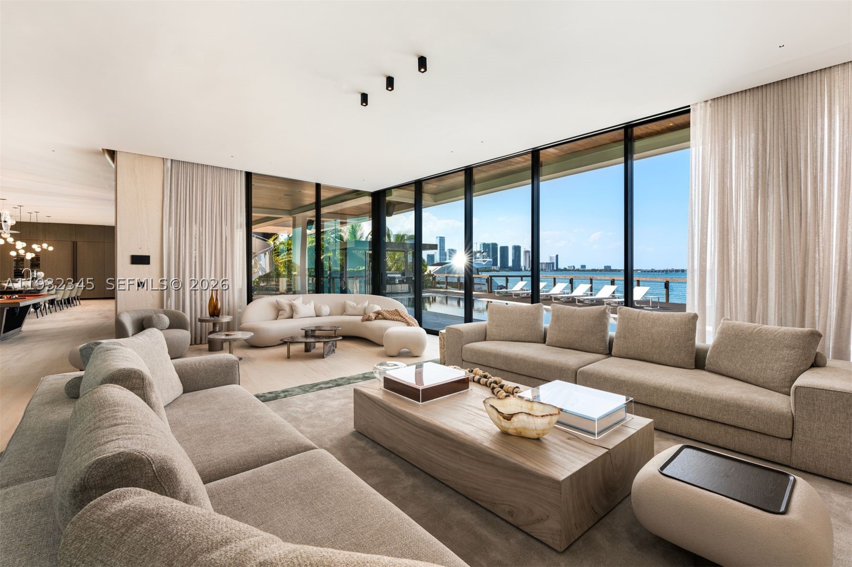 One of the most exceptional waterfront residences in Miami. This striking architectural estate offers 10,689 SF of luxurious interior living plus an additional 8,000 SF understory, featuring 7 bedrooms, 7.5 bathrooms, 12-foot ceilings, and expansive open living and entertaining spaces wrapped in walls of glass.

An elevated waterfront terrace opens to a dramatic 70ft knife-edge pool and spa, summer kitchen, and extended deck with sweeping open bay and downtown skyline views, all set behind a rare 14-foot seawall. The home includes dual kitchens (display and staff), a state-of-the-art theater, private elevator, rooftop deck, and an innovative understory accommodating up to 10 vehicles.

High-end finishes include Boffi kitchens and baths, Apure and Lumifer lighting, Ornare closets, and more. Situated on a 13,382-SF lot with 103 feet of prime waterfrontage, the property also features a new deep-water dock for a large yacht and a 30,000-lb boat lift.