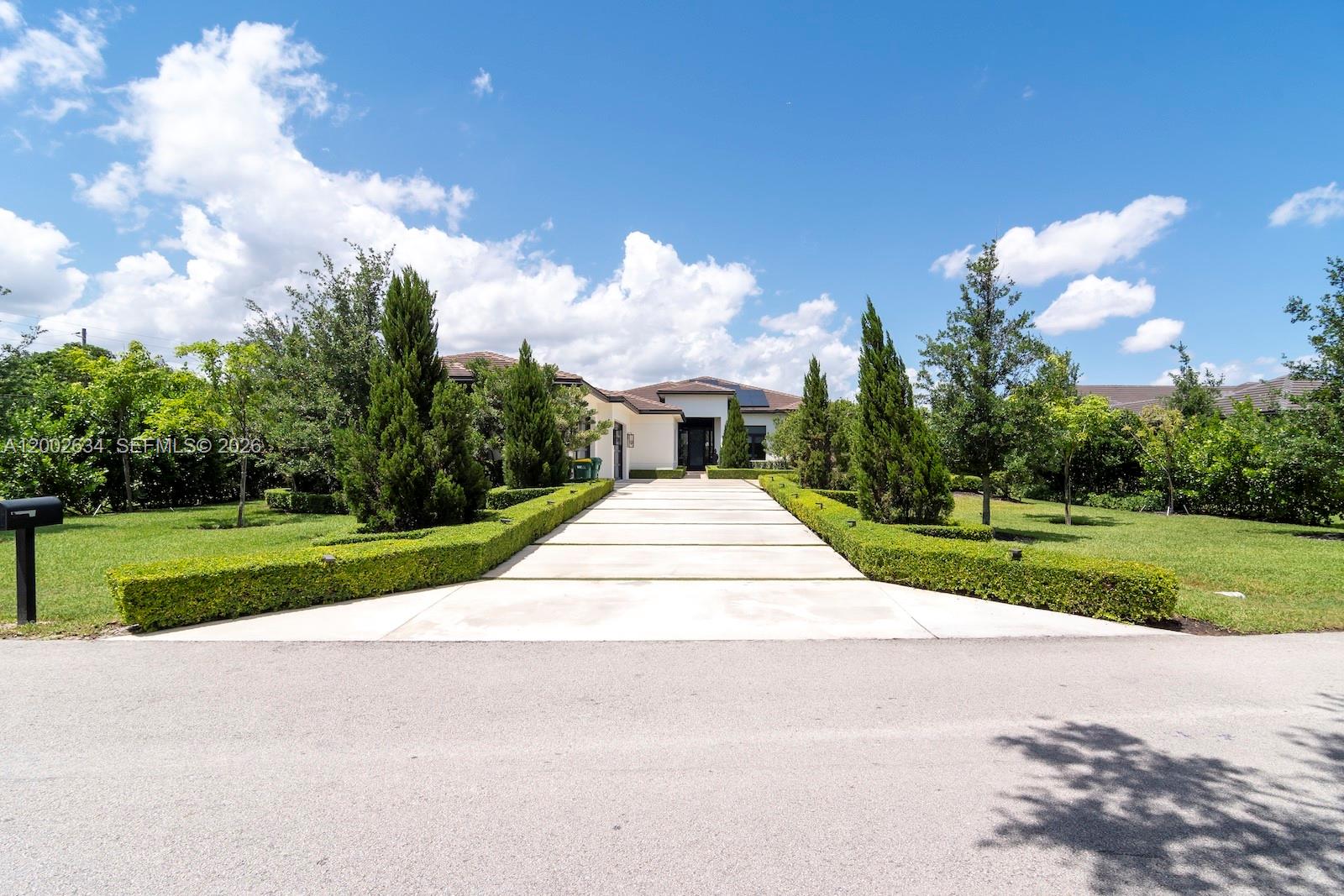 Welcome to one of the most luxury and sophisticated houses in Plantation Acres. Ready to move in. Strategic and convenient location, 4 minutes by car to AHS school. 6 spacious bedrooms, 8 elegant bathrooms, 1 half bathroom, 1 office/suite guest house, home theater, laundry room with fridge and refrigerator, automation room, pantry, professional gym and air-conditioned garage for 4 cars. Total area under roof 9,121 sqft distributed on the following; main house 6,102, Office/Guest house 700, air-conditioned garage 1,123, covered patio 1,196. Professional designed Italian gourmet kitchen with high-end wood finishes on the entire house. 5 AC’s machines. Heated Lap pool with wooden deck. Solar panels originating 92% to 100% clean energy. Professional landscaping. POF required.