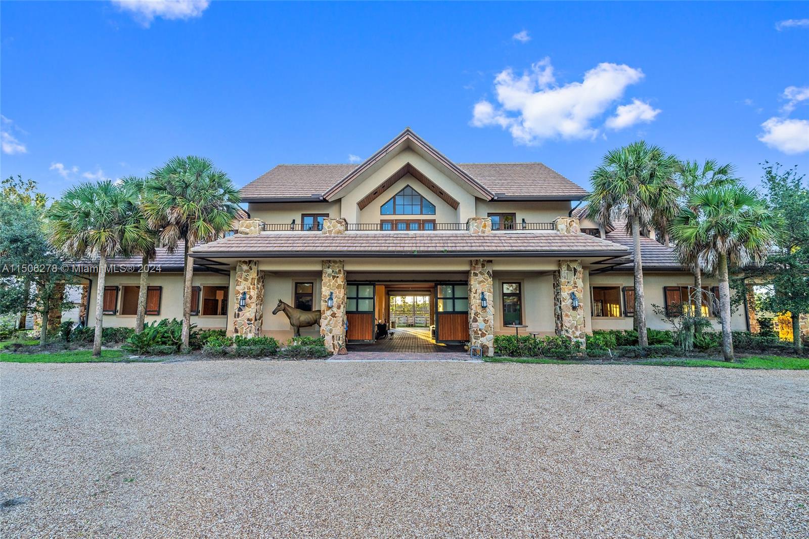 Discover Jupiter's hidden gem, perfect for privacy-seekers, nature lovers and equestrians alike. Seize the rare opportunity to build your custom dream home on this exquisite, ready-to-build property located inside Ranch Colony's Estate subdivision. Nestled between preserves this beautifully manicured 20-acre property is one of the driest lots available. Enter this private property through gated entrance with tall hedges and down a winding 8'' reinforced concrete driveway through breathtaking landscape and beautiful ponds, bridge, and white sand 'beach'. Experience the pinnacle of equestrian luxury inside the main barn featuring 10 oversized 15' x 16' stalls. This hurricane rated Show Barn is equipped with state-of-the-art features including: