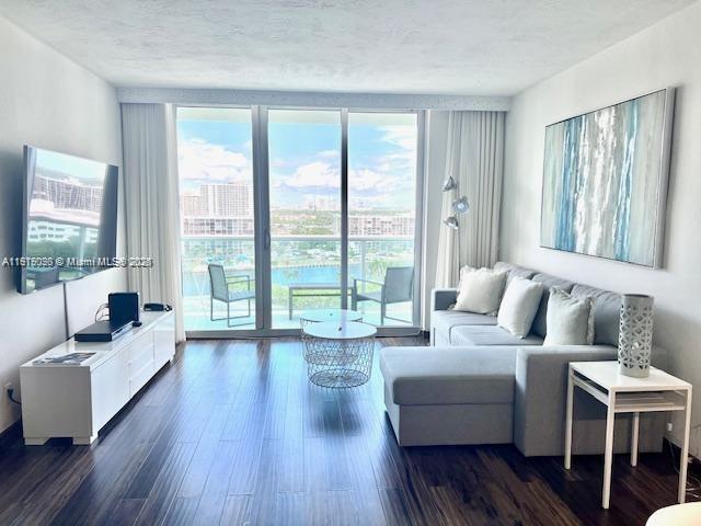 The Tides complex on the beach offering covered parking, convenience store and beach service. This two-bedroom/ two-bathroom , unit is completely renovated with laminated floors, wood doors, updated bathrooms and kitchen including premium appliances and WASHER AND DRYER inside the unit. Balcony with west view of intracoastal and city skyline. Short time rentals allowed.