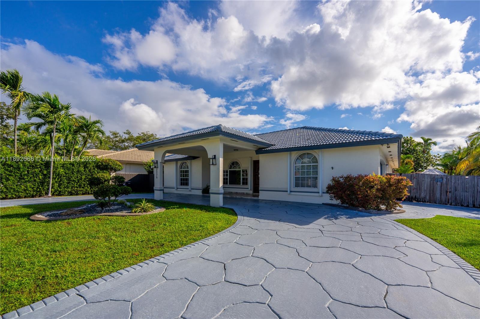 The most desirable 1 story property in the area with porte-cochere, circular driveway and a converted 2 car garage. This 4 Bed/3 Bath home sits on an exclusive 9,972 Sq Ft corner lot on a quiet palm tree lined street. Main house has 4 bed/2 bath, plus a 1 bed/ 1 bath in-laws quarter with separate entrance totaling 3,229 Sq Ft.  The grand entrance leads into a spacious living room and formal dining room. The large open concept Chef's kitchen is enhanced with granite countertops, two large islands, and lots of cabinetry. French doors open up to an entertainer’s dream backyard which has an outdoor kitchen with a built-in grill, a space for entertaining, seating area, a tropical sparkling pool, and a side yard area with space for a boat or an RV. Located near Top rated schools! Welcome Home!