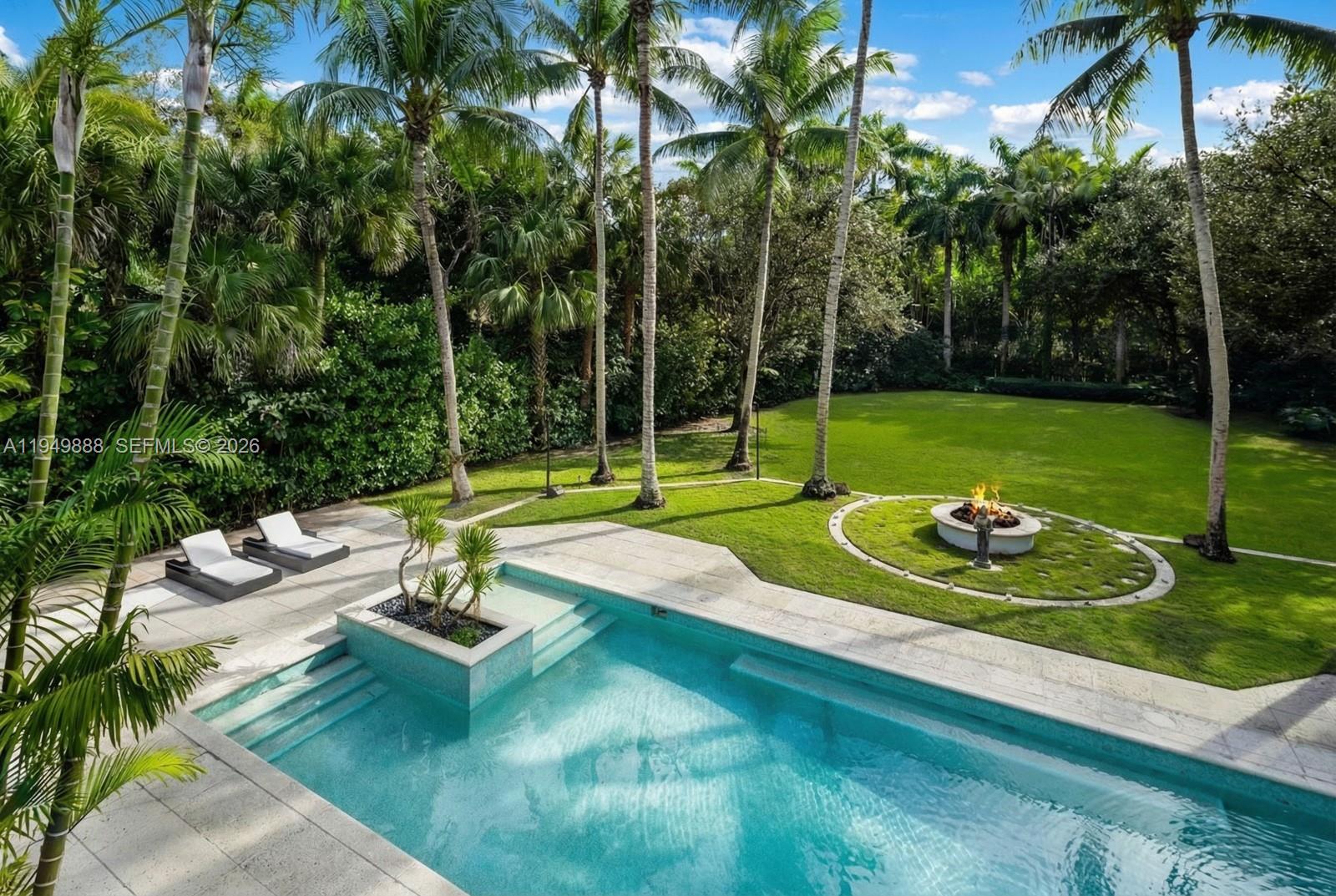Discover this stunning, modernized Mediterranean estate on nearly an acre in the coveted Ponce-Davis neighborhood! Boasting 6 en-suite bedrooms and 7.5 baths, the home features a chef’s kitchen with Thermador appliances and a spacious walk-in pantry, flowing seamlessly into expansive living and dining areas. The primary suite is a private retreat with three walk-in closets, a spa-like marble bath with jetted tub, dual showers, and a terrace overlooking the lush grounds. Designed for entertaining, the expansive backyard offers a heated saltwater pool and spa, firepit, and multiple covered outdoor spaces. Complete with a private gym, 3-car garage with AC, full-home generator and a brand-new roof, this gated oasis combines elegance, comfort, and ultimate privacy.