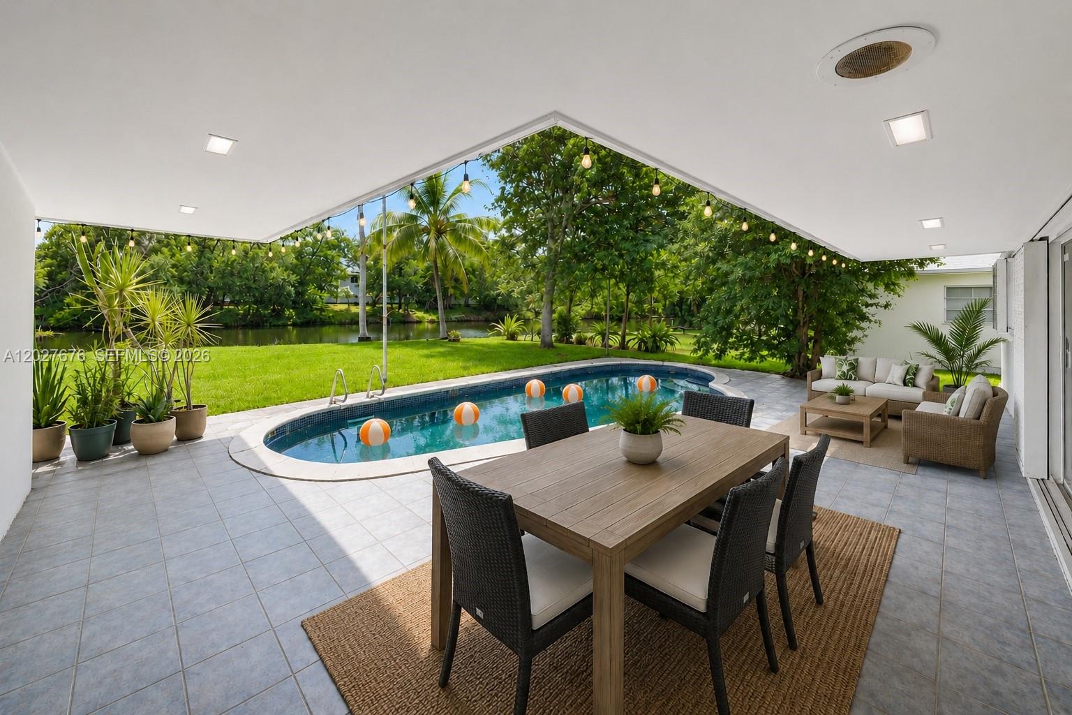 A Private Waterfront Retreat in Biscayne Gardens. Set on an oversized 12,150 SF canal-front lot with 75' of water frontage, this 3BD, 2BA residence offers a rare combination of privacy, space, & indoor-outdoor living. Surrounded by mature trees & lush tropical landscaping, the home enjoys serene canal views & a peaceful setting that feels worlds away while remaining close to everything Miami has to offer. The home features an open-concept layout filled with natural light, impact windows & doors, & picturesque views of the water & greenery from multiple rooms. A dedicated media lounge with projector creates the perfect setting for movie nights, working from home, relaxing, or additional flexible living space. The outdoor space is the true centerpiece — a private backyard retreat with a sparkling pool, covered patio, expansive green space, & endless possibilities to create gardens, entertainment areas, or expand the residence over time. The oversized lot is one of the property's most compelling features, offering exceptional value & flexibility in a rapidly growing neighborhood. A rare 2-car garage adds flexibility for parking, storage, hobbies, or future lifestyle needs. Residents enjoy easy access to Miami Shores Country Club, The Cushman School, neighborhood parks, shopping, dining, & major commuter routes. The beaches, Bal Harbour, Aventura, Design District, & Wynwood are within approx. 15 mins. More than a home — this is a private Miami escape with room to grow.