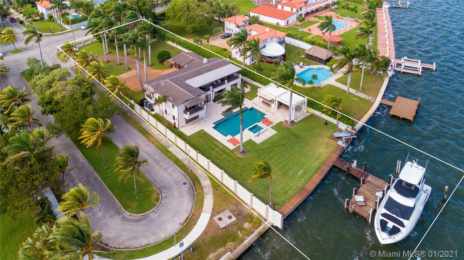 Modernized and updated transitional-style home in Miami’s Upper East Side, Morningside. Make this mansion your private sanctuary and enjoy glorious sunrises and sweeping bay views from the living areas, chef’s kitchen, formal dining, and 4 bedrooms. The mega-size master suite features vaulted ceilings, modern bath, custom walk-in closets, and an immense covered terrace. Ideal for boaters and those who want vast land, this lushly manicured 30,100-SF corner property offers 100-FT of waterfront with a new dock, huge backyard with a cabana house, an outdoor bar, cabana bath, and an impressive front-yard with a long driveway. Morningside is a historic and guard-gated neighborhood with wide, tree-lined boulevards and lavish bayfront estates, located minutes to the Design District.
