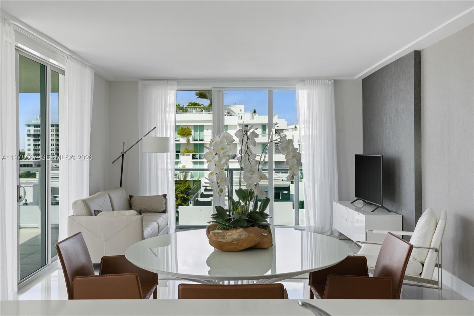 This unit features a modern design with 2 bedrooms and 2 bathrooms. A bright apartment with floor-to-ceiling windows that fill the space with natural light. The spacious balcony includes an outdoor gourmet kitchen, ideal for entertaining guests. Located on the eastern island, steps from Bal Harbour Shops, top-tier cafés, and fine restaurants, close to the beach and some of the best schools in Miami. The building offers sophisticated amenities, including a rooftop pool with panoramic views, jacuzzi, gym, ample storage areas, and two parking spaces with direct elevator access. The unit is been sold fully furnished and decorated.