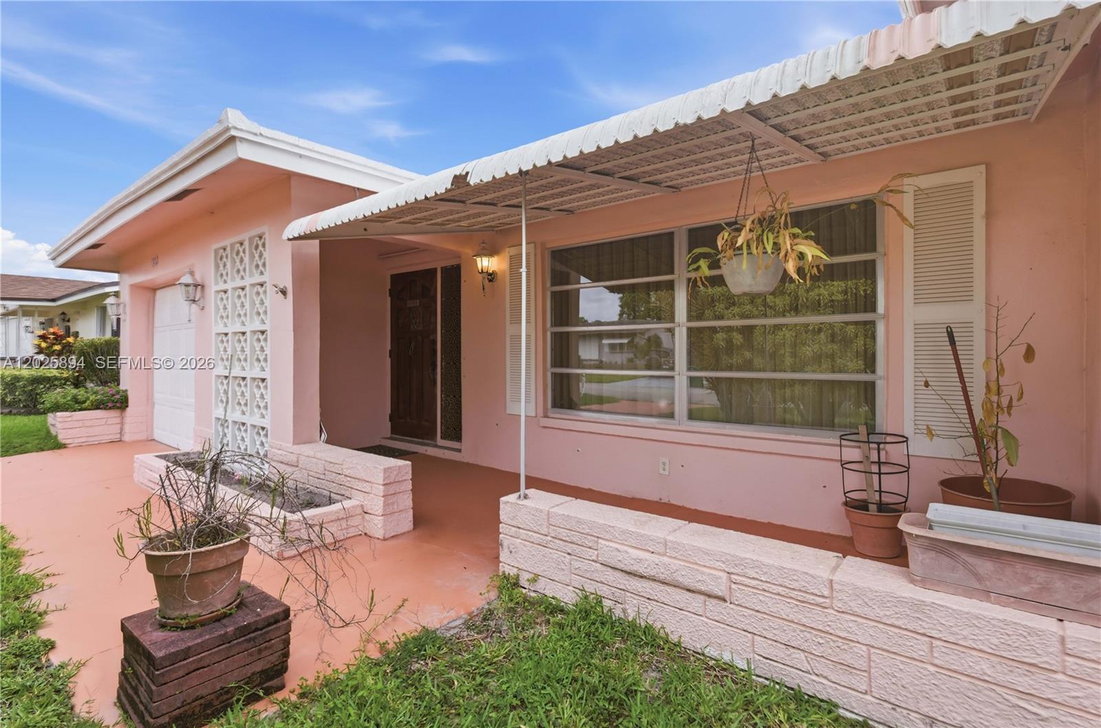 Well-maintained 2-bedroom, 2-bath home offering 1,579 sq ft of comfortable living in the sought-after Mainlands of Tamarac, a vibrant 55+ community. Featuring a spacious one-car garage and a functional, original layout with great bones — this is the perfect canvas for buyers looking to personalize their dream home. Enjoy resort-style community amenities including a pool and clubhouse, all just minutes from Commercial Blvd, major highways, shopping, and dining. Low-maintenance Florida living at its finest.