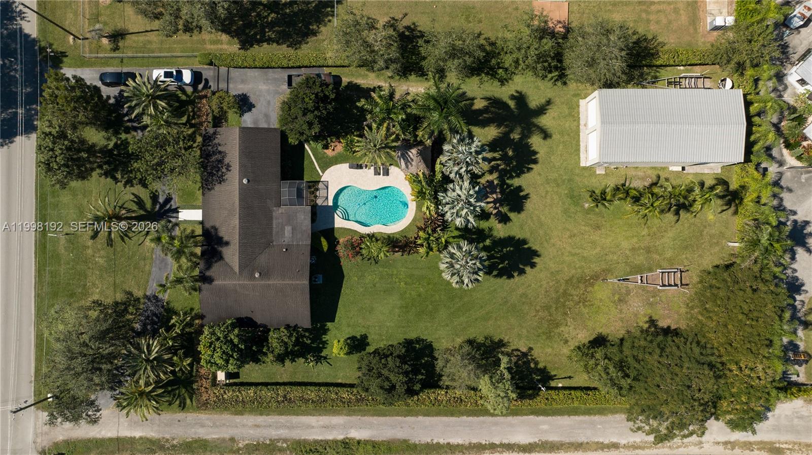 Welcome to your private Redland compound—where space, freedom, & functionality come together on over an acre in the heart of Homestead. This is not your typical home. Designed for those who need more than just a place to live, this property offers a rare combination of residential comfort & serious utility. Whether you’re a business owner, car enthusiast, or simply someone who values room to spread out, this property delivers. The standout feature is the impressive 60x30 hurricane-rated warehouse, perfect for storing equipment, running a home-based business, housing multiple vehicles, or creating the ultimate workshop. With ample parking and wide access, there’s plenty of space for boats, RVs, trailers, & more. The interior offers generous living spaces, an updated kitchen, impact windows for added protection, & plantation shutters throughout, creating a solid foundation you can easily personalize. Step outside & enjoy your own backyard retreat, complete with a pool, tiki hut, fruit trees & expansive outdoor space ideal for entertaining or relaxing in total privacy. Additional highlights include a full-home generator, providing peace of mind year-round, & a fully fenced lot with gated entry for added security. Located in the sought-after Redland area, you’ll enjoy a quiet, agricultural setting while still being just a short drive to the Florida Keys/Miami. Opportunities like this are rare-properties that offer this level of flexibility, land, &utility don’t come around often.
