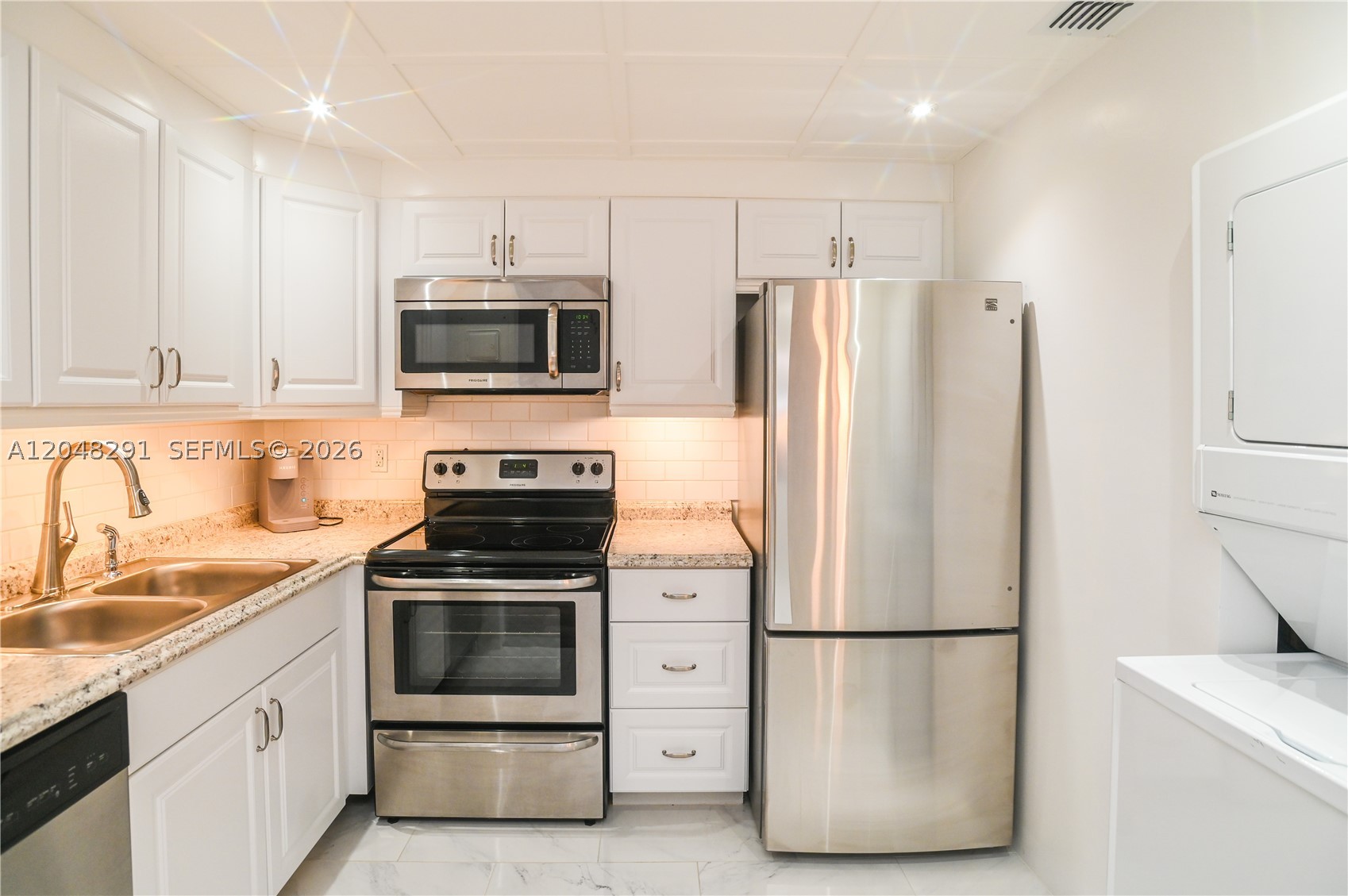 Welcome home to this beautifully updated waterfront condo featuring a thoughtfully designed custom kitchen w/stainless steel appliances, custom cabinetry, elegant kitchen ceiling details, and the convenience of an in-unit stackable washer and dryer. The spacious living & dining areas offer additional custom storage cabinets, a decorative fireplace, and an abundance of closet space throughout. Enjoy peace of mind with impact windows and a new impact-rated sliding glass door leading to a large screened patio overlooking tranquil water views, the perfect place to relax and unwind. Both bathrooms have been beautifully updated, and the A/C was replaced in 2023. The community offers resort-style amenities including a swimming pool over looking the water, equipped fitness center, clubhouse with kitchen, barbecue area, sauna, game room, and dockage for boating enthusiasts with ocean access. The building features a new roof, and the concrete restoration project is nearly complete with all assessments paid in full by the seller. Don’t miss this opportunity to own a move-in ready waterfront unit with exceptional upgrades and outstanding amenities. Located just minutes from restaurants, shopping and beaches. This is a must see!!!
