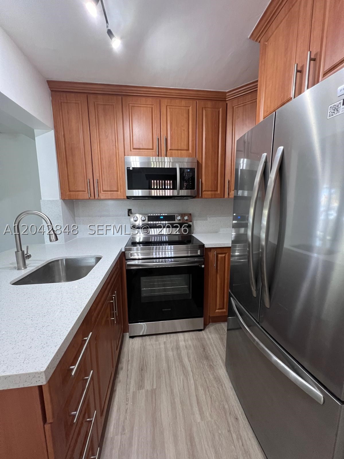 First floor 2/2 condo in Lago Grande. Gated community with security guard at gate. The kitchen features stainless steel appliances, white quartz counter tops, wood cabinets. PVC floors throughout the unit. Renovated bathrooms. Washer and dryer in unit. 1 assigned parking space + guest parking. Commercial vehicles not allowed. Small pets up to 20 lbs allowed with landlord's authorization. Community features swimming pool, kid's play area, management on-site, security guard at gate, security patrol. Association can take up to 20 days to process applications. Utilities not included. EASY TO SHOW.