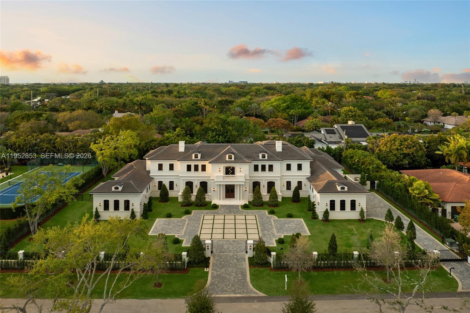 Brand-new Château St. Marie is a timeless French-inspired estate by acclaimed architect Ramon Pacheco, with interiors by Orballo’s Maribel Muniz, ideally set on a prestigious street in the heart of North Pinecrest near top-tier schools. Situated on a 37,897-SF lot with 9,644 SF of refined living space, the home features soaring ceilings, marble floors, bespoke European millwork, dramatic chandeliers, and a stately fireplace. The chef’s kitchen offers premium designer appliances and custom cabinetry. Resort-style grounds include an azure pool with water features, decorative bowls, Jacuzzi, fountains, covered terraces, and a summer kitchen. The residence boasts 7 bedrooms, 8 full baths, 2 half baths, dual primary suites on both levels, guest suite, walk-in wine cellar, home theater, 150 kW full-home residential generator, gated entry, and a 3-car garage with lift capacity.