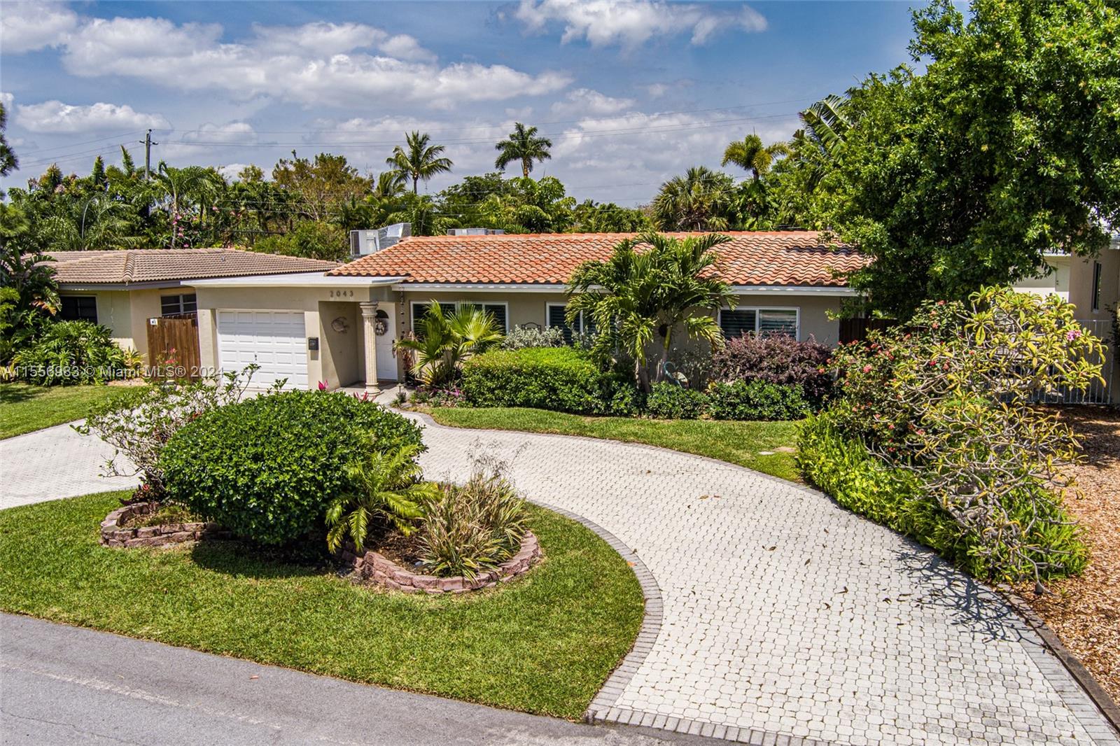 Lush tropical oasis minutes from the beach.  This three bedroom, two bath pool home is nestled in the hidden gem neighborhood of Coral Shores.  Minutes from shopping, dining, downtown Ft Lauderdale, the Beach and I-95.  Newly remodeled kitchen and master bath by Allied Kitchen and Bath. New roof 2020, heated salt pool and jacuzzi just steps from the primary bedroom and family room.  Two full size a/c units. Enjoy complete privacy on your back patio, fenced and  surrounded by tropical foliage. Hardwood floors in the bedrooms and tile throughout the living area. Plantation shutters on all the front windows.  All impact windows and doors, including the garage door. Indoor  laundry room.