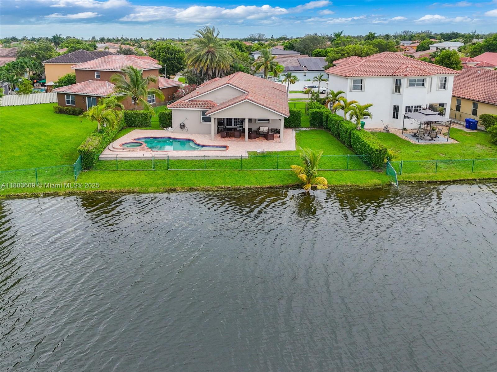 This beautifully remodeled single-story lakefront home is tucked away on a peaceful street and sits on an oversized lot of nearly 10,000 sq. ft. with more than 80 feet of water frontage, offering stunning sunset lake views, & a fully private yard with a pool, spa, & custom covered terrace ideal for entertaining. Featuring 4 bedrooms & 3 bathrooms, the home offers a split floor plan, high ceilings, a remodeled kitchen & bathrooms, oversized porcelain tile floors, crown molding, recessed lighting, & spacious living, dining, & family rooms. Large primary suite, walk-in closet, upgrades such as a newer tile roof, accordion shutters, & a 2-car garage add peace of mind. Somerset Country Club/Vizcaya is a 24-hr gated community, easy access to I-75, the Florida Turnpike, shopping, and dining.