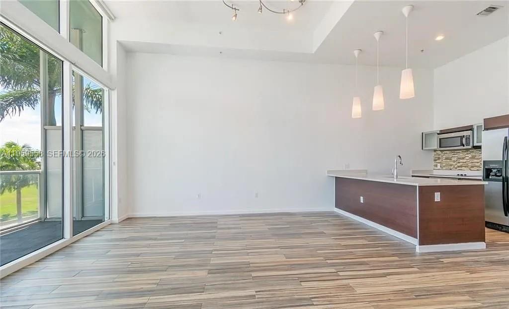 Experience luxury living at Quantum on the Bay!  Gorgeous, updated loft style condo in Quantum on the Bay! Bayfront building with unit views of the Bay! Open Euro style kitchen w/Quartz countertops, Whirlpool appliances, new backsplash, vaulted ceilings, high quality new "wood look" ceramic tile flooring, new full washer\dryer, large closet, impact glass. Enjoy breathtaking views from your private balcony. Quantum offers top-tier amenities, including two pools, a state-of-the-art gym, a theater room, and 24/7 concierge service. Located in Edgewater, you're steps from Margaret Pace Park, dining, and shopping, with easy access to Downtown and Miami Beach. Don’t miss this incredible rental opportunity— Schedule your showing today!