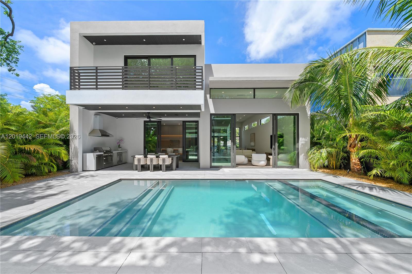 A striking contemporary estate in Buena Vista designed around volume, light, and seamless indoor-outdoor living. This 5-bed, 6-bath residence features custom closets, massive living spaces, walls of glass, and dramatic scales. The white oak floors, custom lights, and clean architectural lines create a refined but comfortable atmosphere. The main living spaces open effortlessly to the resort-style pool, creating the feeling of ultimate paradise. The kitchen is finished with natural stones, integrated lighting, and a full suite of high-end appliances, designed both as a functional workspace and a centerpiece for entertaining. Smart home technology, Sonos audio, and a comprehensive security system elevates the everyday living experience. A detached wellness center adds flexibility, and includes its own sauna, cold plunge, bathroom, and fully equipped kitchen. Located just minutes from the Design District, Downtown Miami, and Miami Beach, this home delivers modern luxury in one of Miami’s most connected neighborhoods.