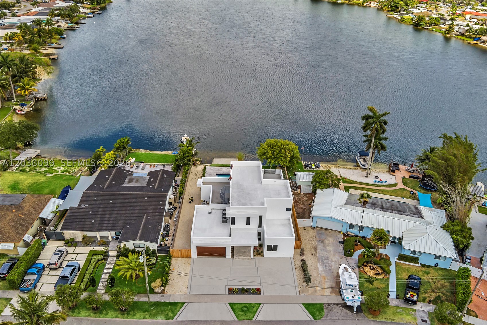 Newly constructed 3,900 SF plus Westwood Lakes home. Stunning Two-Story waterfront retreat with Spacious Living and a roof top deck. Welcome to this exceptional two-story residence that was completed in 2025. Boasting 5 spacious bedrooms and 6.5 bathrooms, this home offers the perfect balance of sophistication and functionality with waterfront views. Step inside to soaring ceilings and an open-concept layout, where natural light floods the living spaces. The kitchen, complete with high-end appliances and stylish finishes, is a chef’s dream, ideal for entertaining and everyday living. Located on a motorized lake. Upstairs, the serene primary suite serves as a private oasis, featuring a spa-like en-suite bath and generous walk-in closet.
