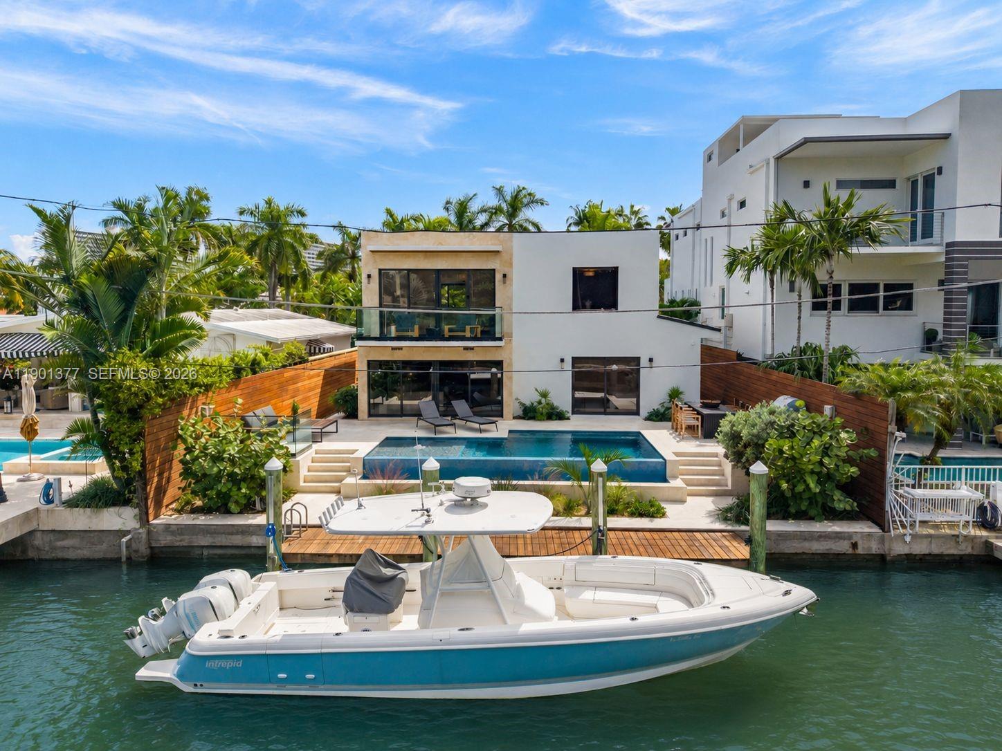 A Modern Boater’s Paradise — This exceptional waterfront residence in Coconut Grove seamlessly blends architectural elegance with contemporary comfort. Completely reimagined, the 4BR/4BA home features Italian porcelain flooring, white oak finishes, bespoke millwork, and Lutron lighting throughout. The chef’s kitchen is a showpiece with Sub-Zero and Wolf appliances, a built-in coffee system, Grand Viola marble countertops, and custom cabinetry. Thoughtful upgrades include a new roof, new impact windows and doors, and new electrical, ACs and plumbing. Outdoors, lush tropical landscaping, a sparkling new pool, summer kitchen, and integrated sound system frame 50 feet of private dockage offering direct, unobstructed bay access. Excellent location close to Brickell and Center Grove.