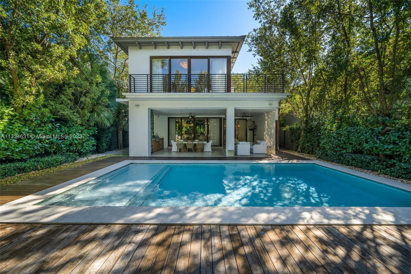 Luxurious coastal living awaits you in this turn-key private retreat in a highly desirable Coconut Grove location! Across the open layout, this contemporary 2-story home is defined by immaculate finishes, volume ceilings with recessed lighting, crisp white tones, and gleaming tile floors. Equipping the avid cook are Thermador appliances, marble countertops, and an oversized waterfall island. The well-sized primary suite has a balcony and an exquisitely tiled ensuite. From the expansive sun deck to the backyard oasis with a covered patio, pool, and built-in BBQ, you'll have incredible outdoor gathering spots. Enjoy a quick commute to fabulous shopping, restaurants, nightlife, Coral Gables, Brickell, downtown Miami, and South Beach. Come for a tour while this gem is still available!